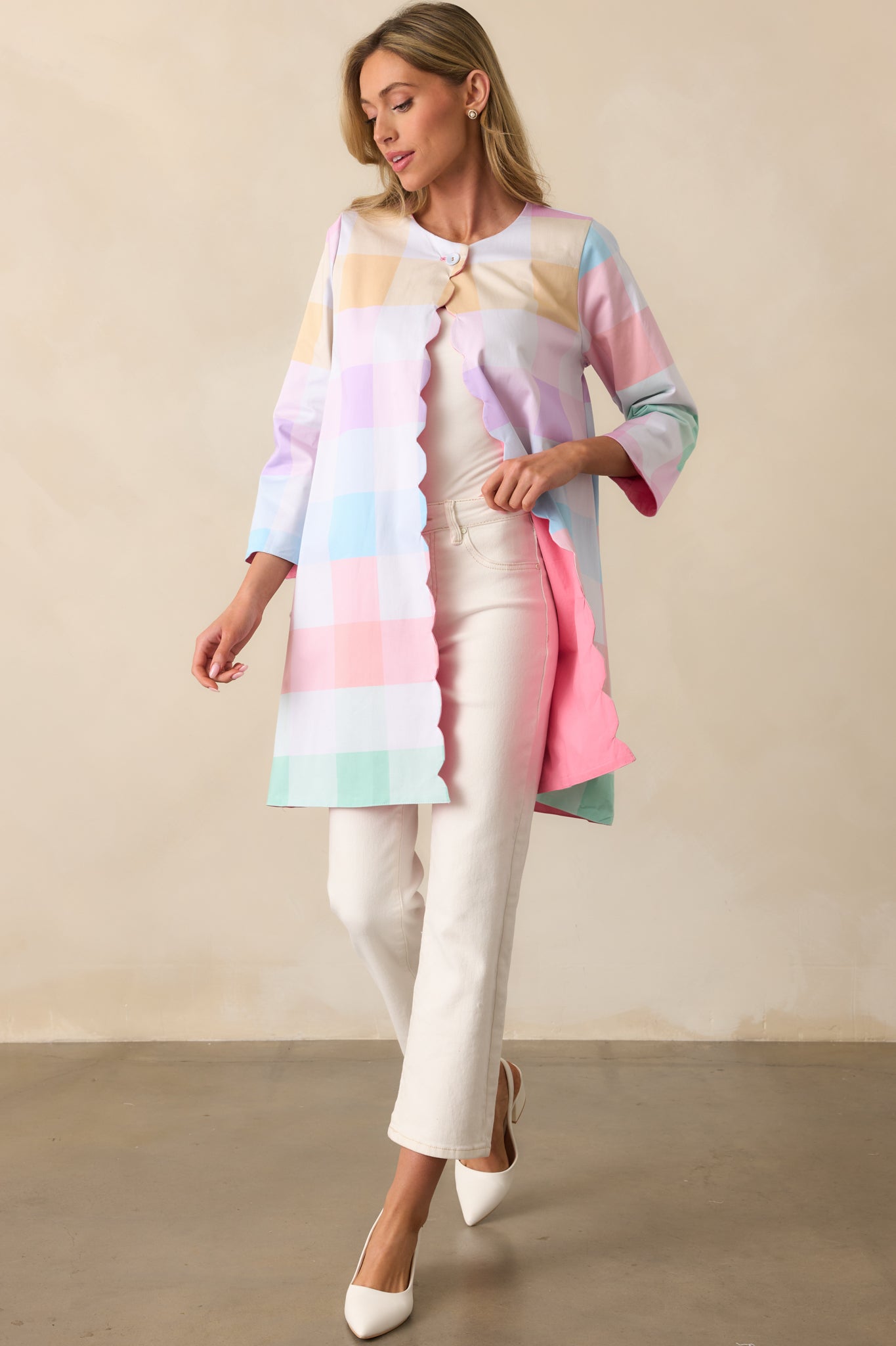 A stylish reversible jacket showcasing its pastel plaid print with scalloped hems and a structured silhouette.