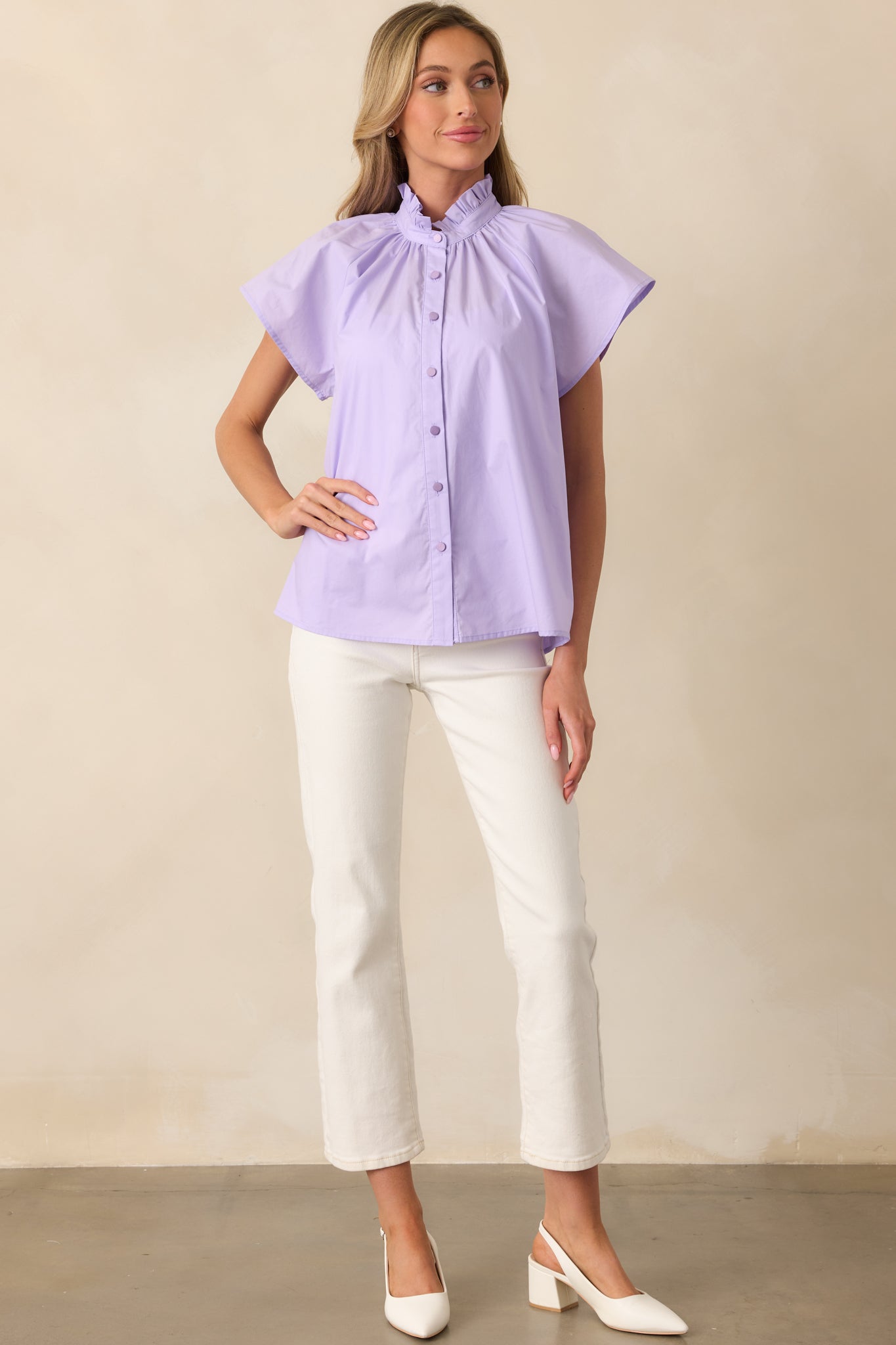 Lilac top featuring a mock ruffle neckline and short sleeves, designed with a functional button front and relaxed fit, perfect for casual or layered outfits.