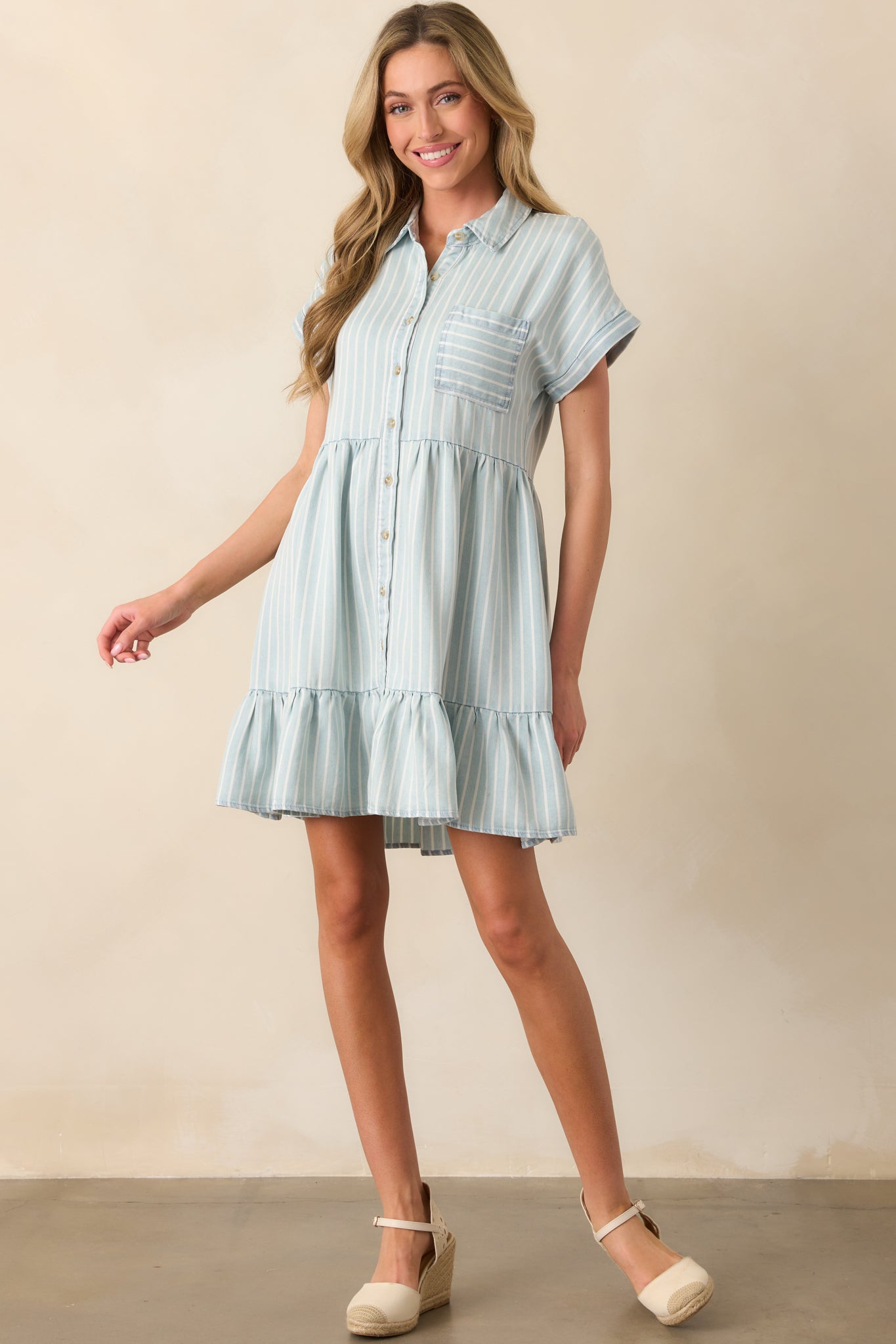 A lightweight chambray dress with a button-front closure, chest pocket, and a relaxed, breezy fit.