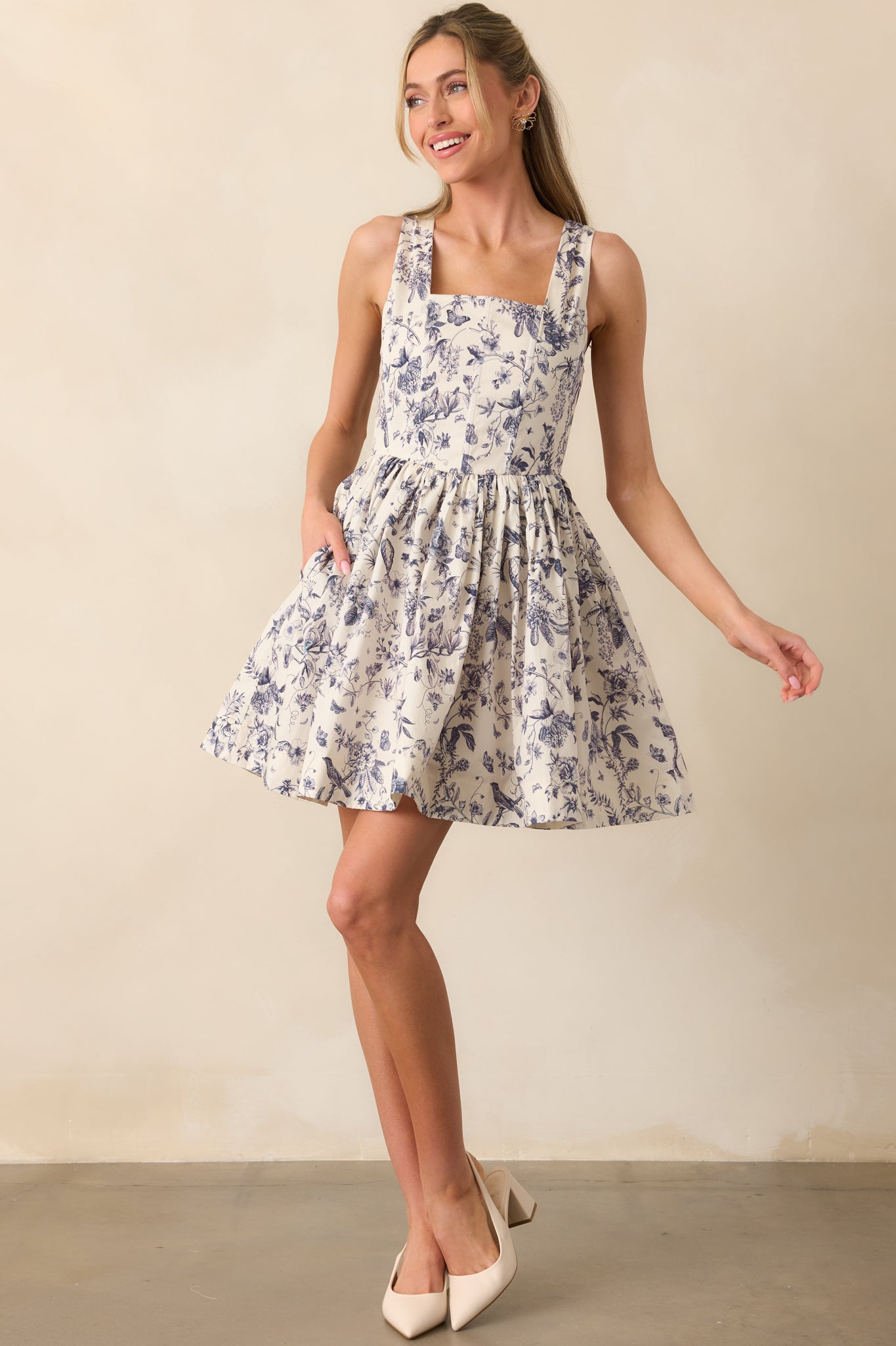 Full-length image of the dress emphasizing the flared silhouette created by the pleated mini skirt.