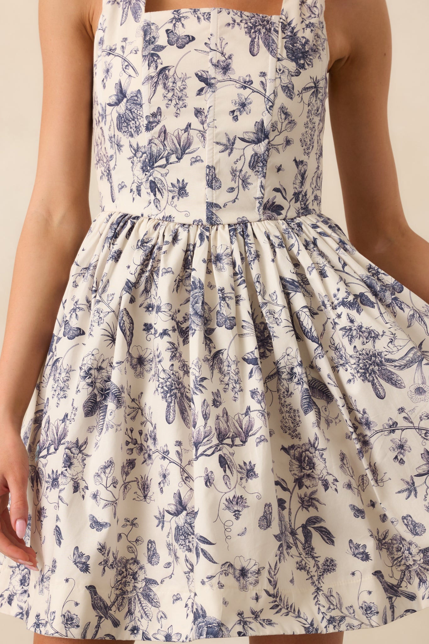 Zoomed-in detail of the floral toile print and stitching along the bodice seam.