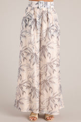 Front view of these pants that feature the tropical leaf pattern of the fabric.