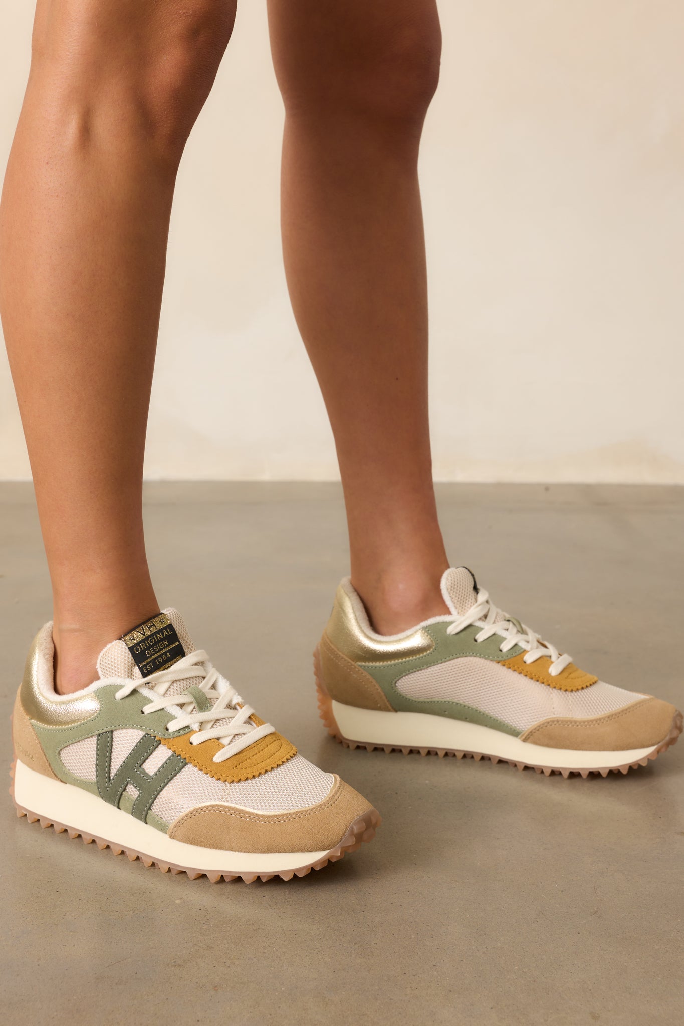 Side profile of camel sneakers highlighting the textured spikey sole and layered camel design.