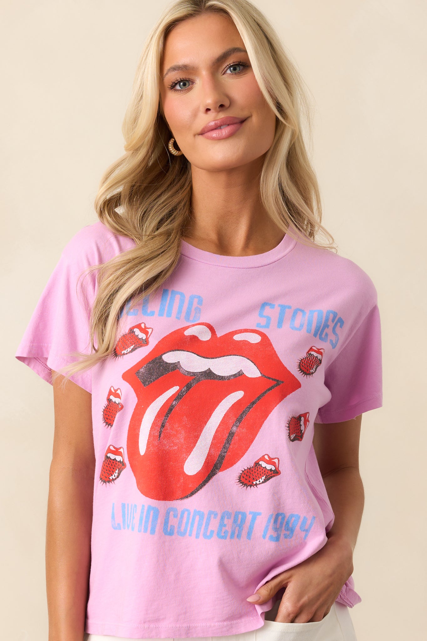 Close-up of the chest area on the pink tee, focusing on the "Rolling Stones Live In Concert 1994" graphic and vibrant lips logo.