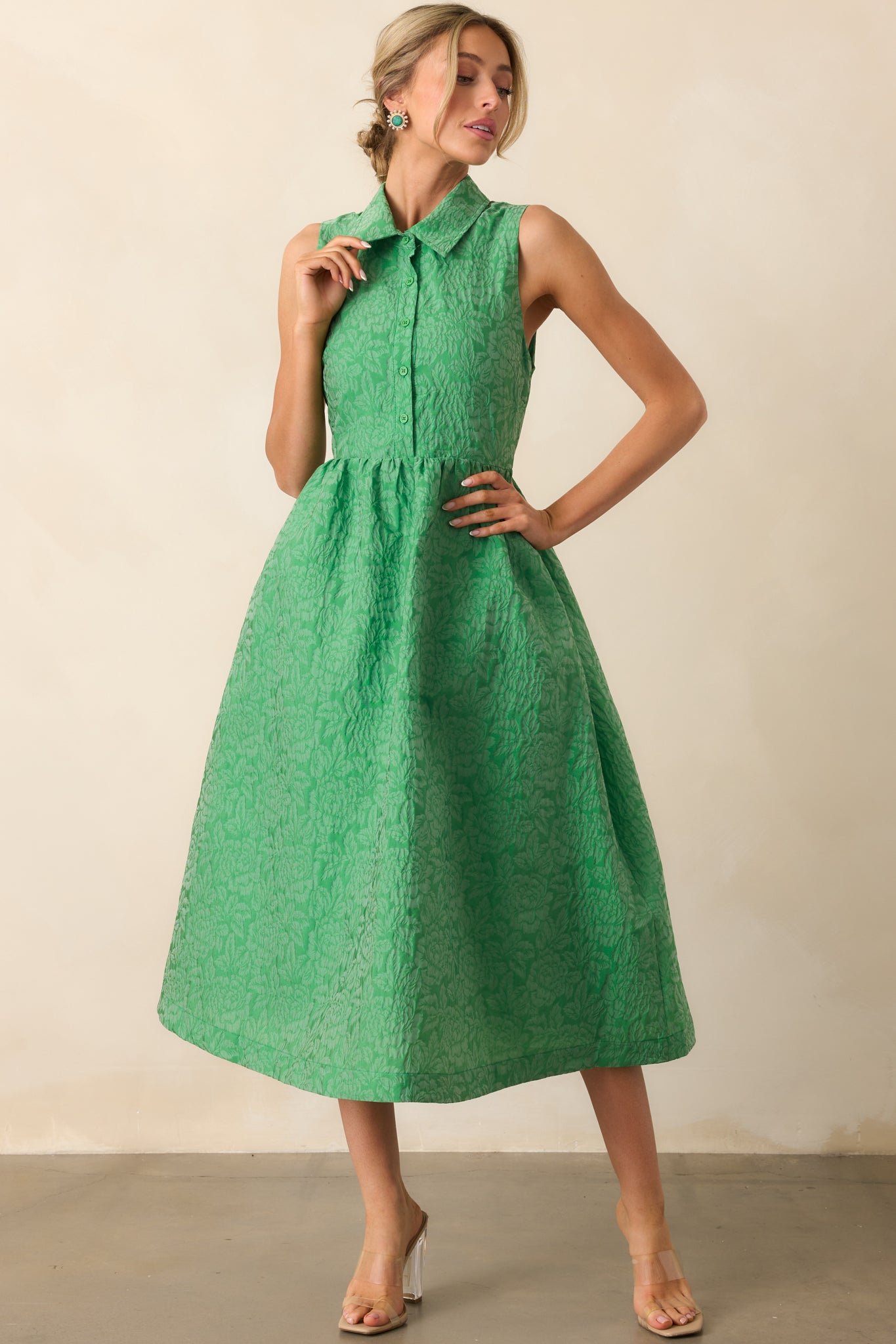 The monochrome floral jacquard fabric brings subtle texture and elegance to this structured midi dress.