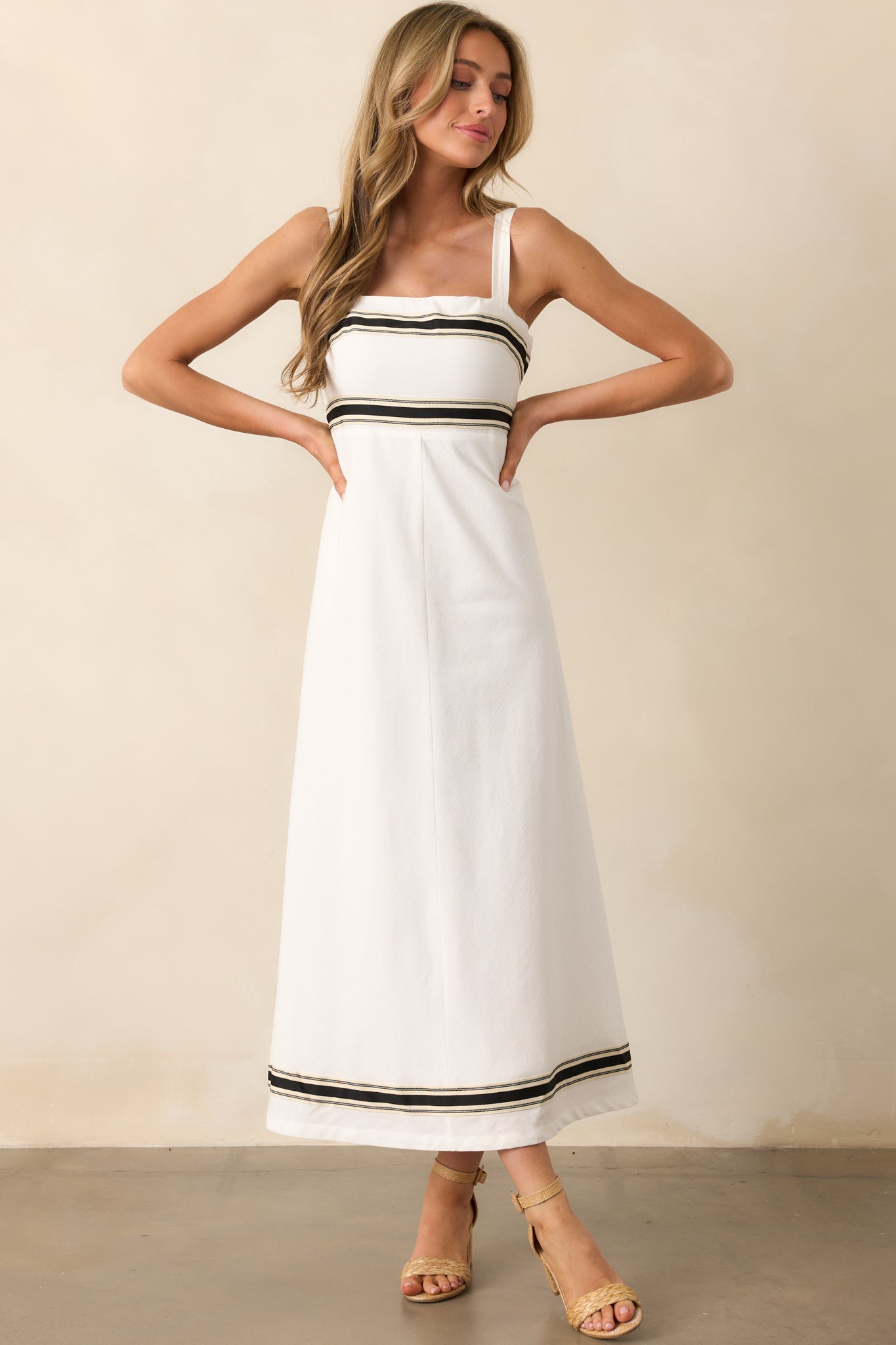 White midi dress with a flattering square neckline, black contrast detailing, and a smooth, flowing silhouette.