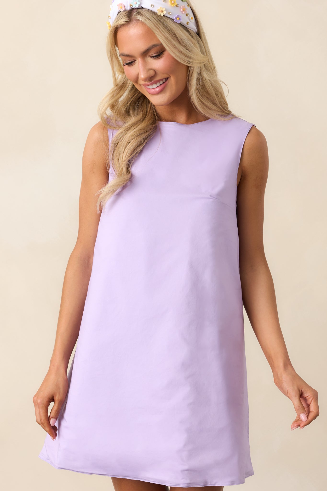 A detailed shot of the sleeveless design, emphasizing the clean lines and flowy fit of the mini dress.