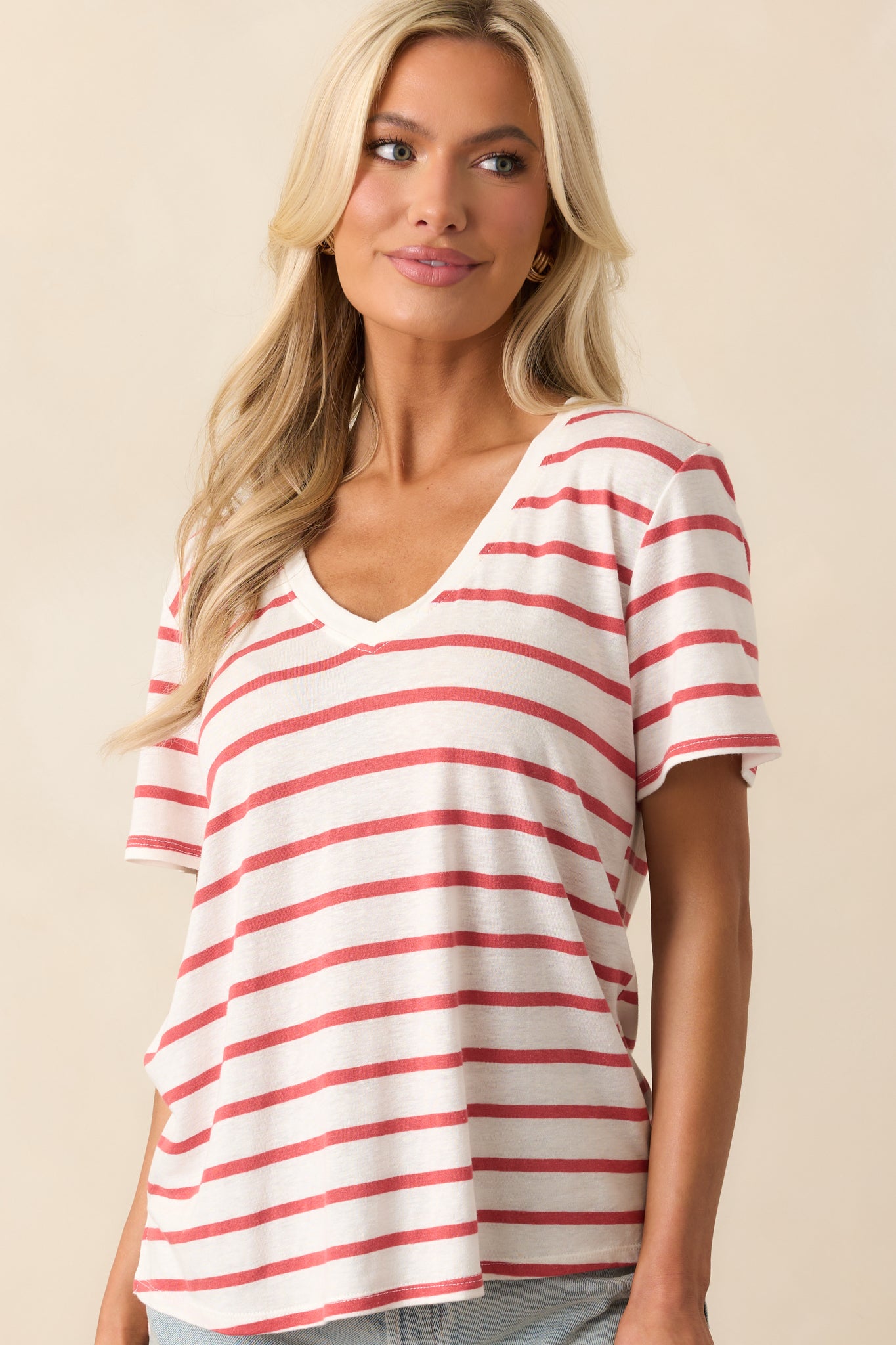Detailed shot of the v-neckline with the top's soft fabric, showcasing the relaxed fit and light, airy feel of the striped design.