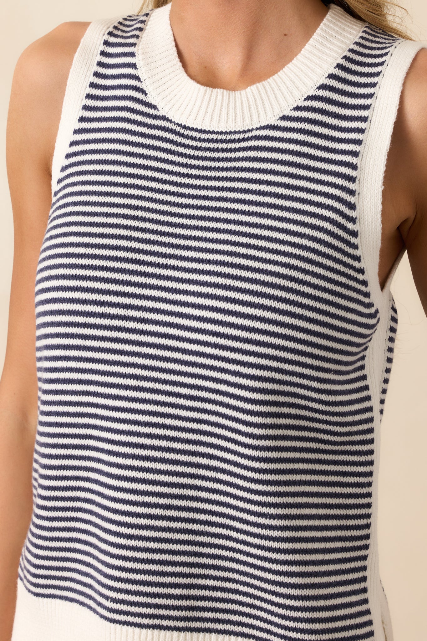 A zoomed-in look at the ribbed hemlines, highlighting the high-quality knit construction and structured finish.