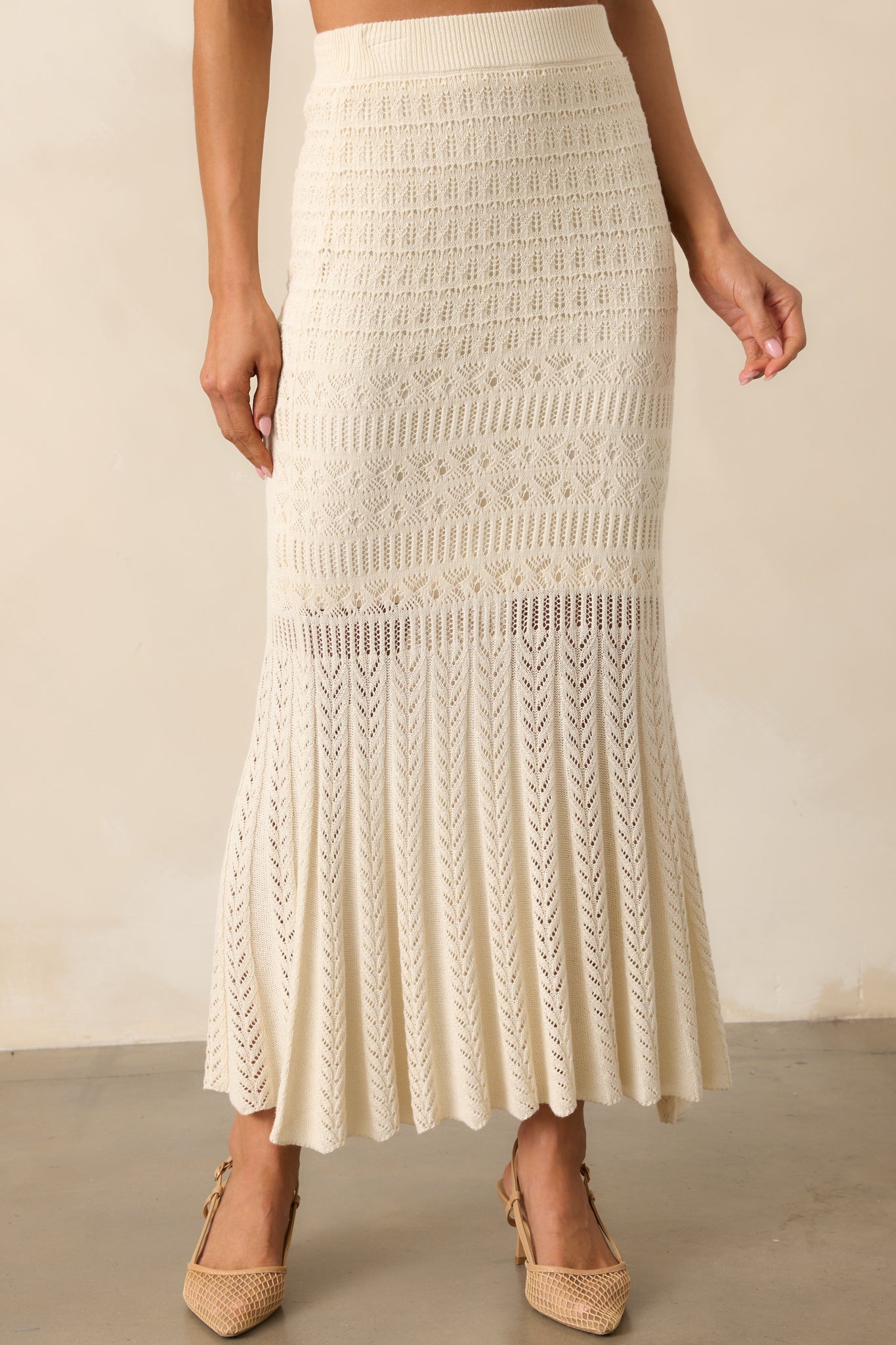 View of the crochet midi skirt, highlighting the flattering body-hugging fit and gentle flare at the hemline.