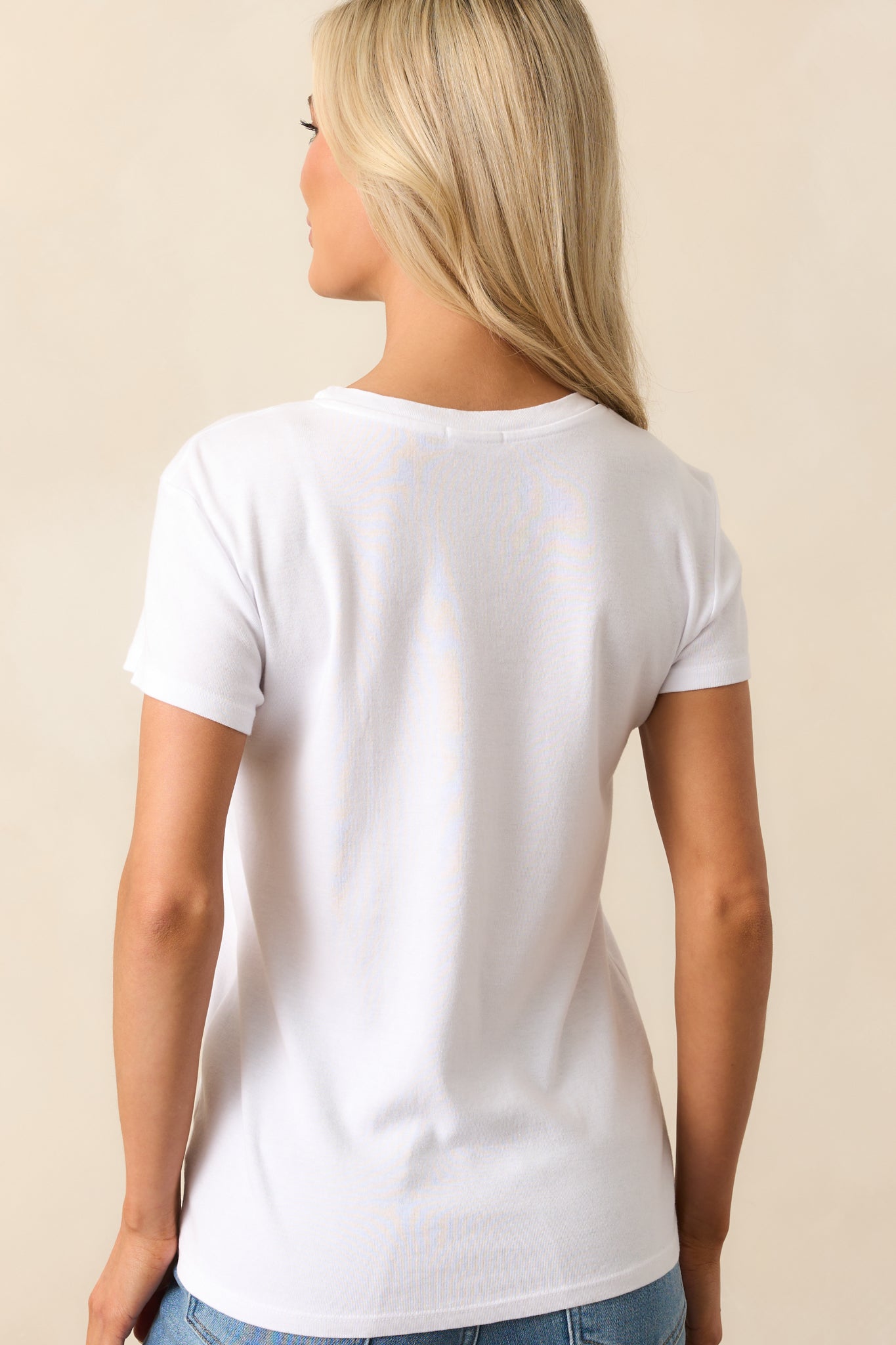 Rear view of white tee showcasing the clean back design, relaxed fit, and soft cotton-blend construction.