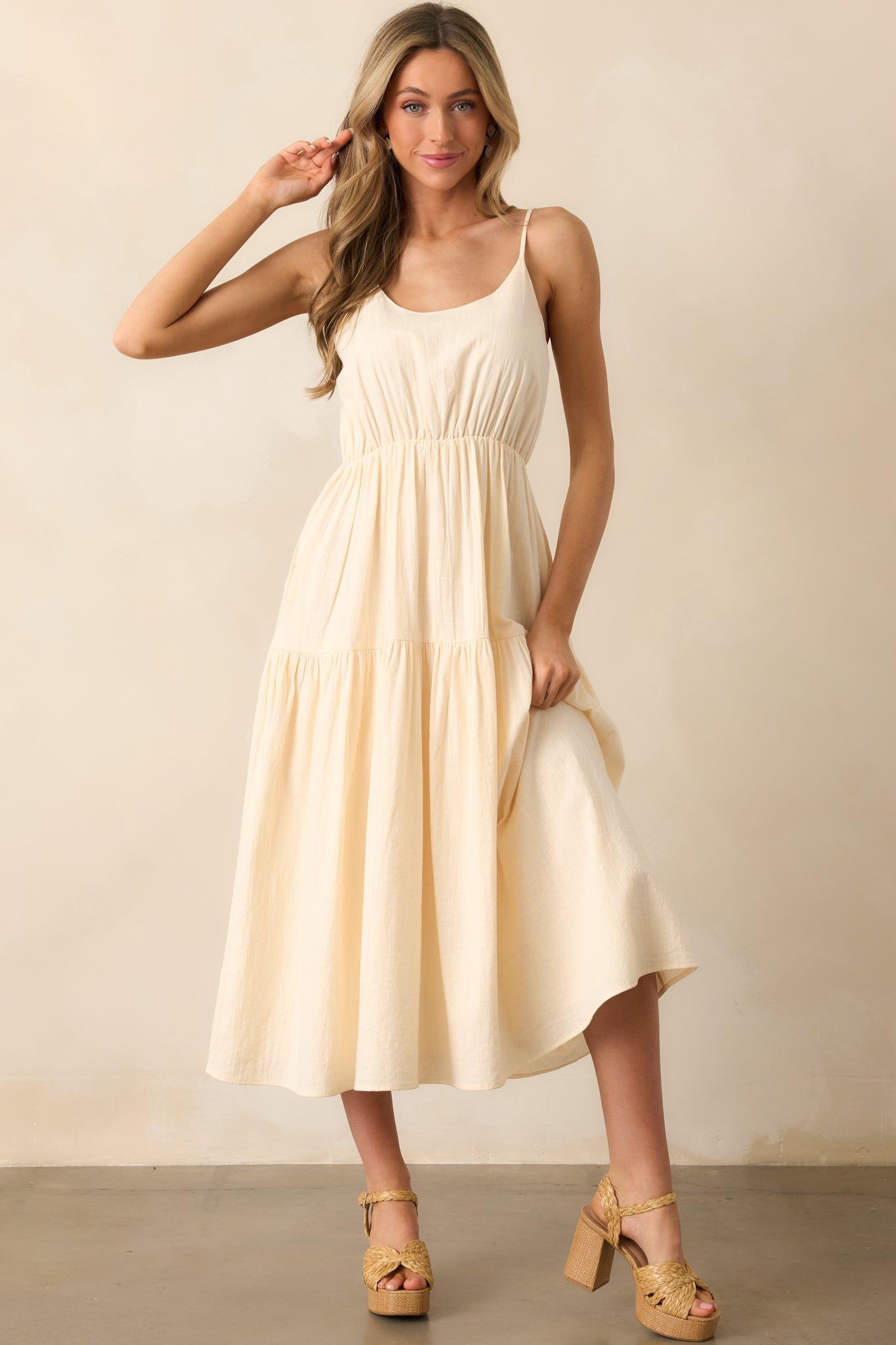 Relaxed-fit midi dress with a cotton tiered skirt, scoop neckline, and adjustable straps.