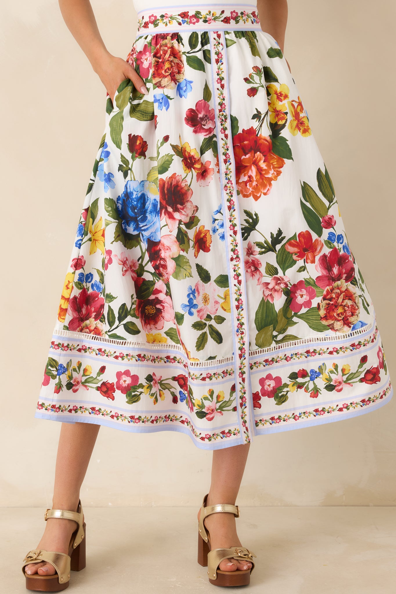 Ivory floral skirt highlighting waistband with intricate border detail.
