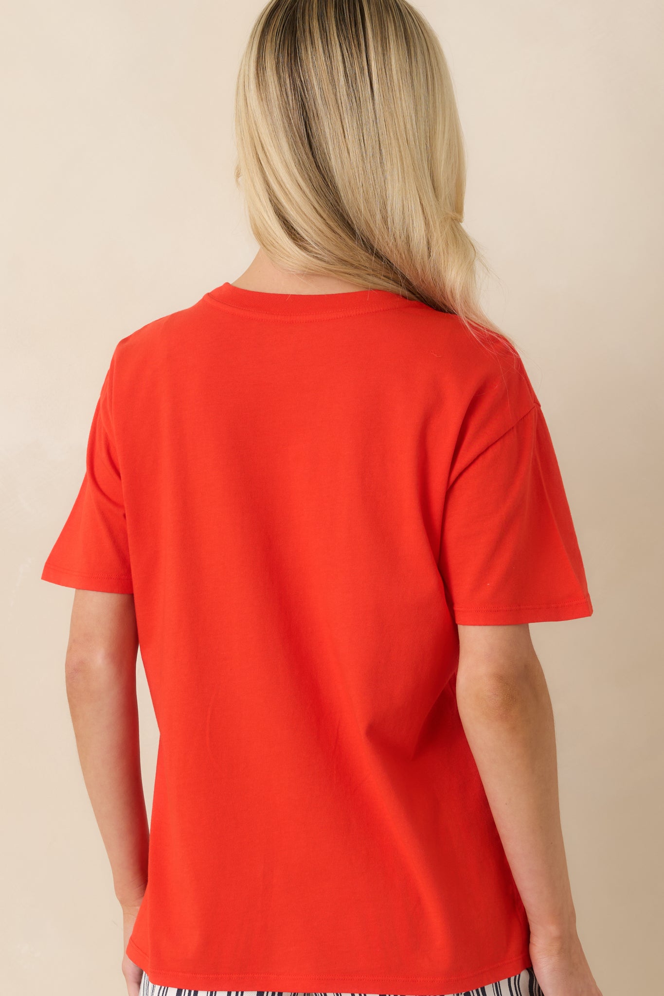 Rear view of the poppy red cotton tee featuring a relaxed boyfriend fit and clean back design.