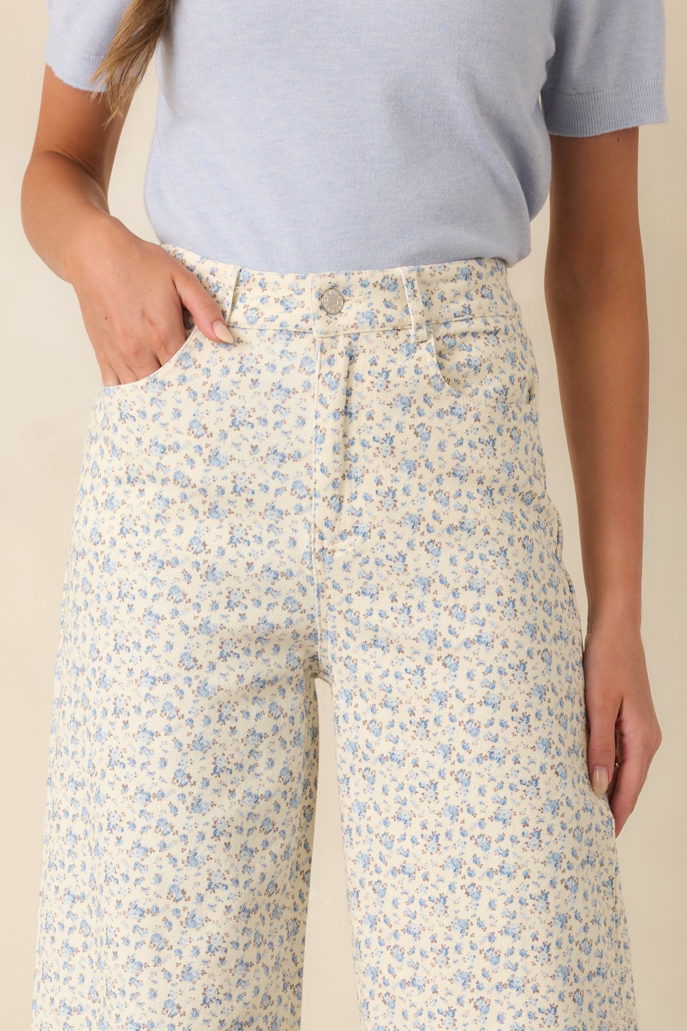Detailed image highlighting the floral denim texture, stitching details, and classic five-pocket construction.