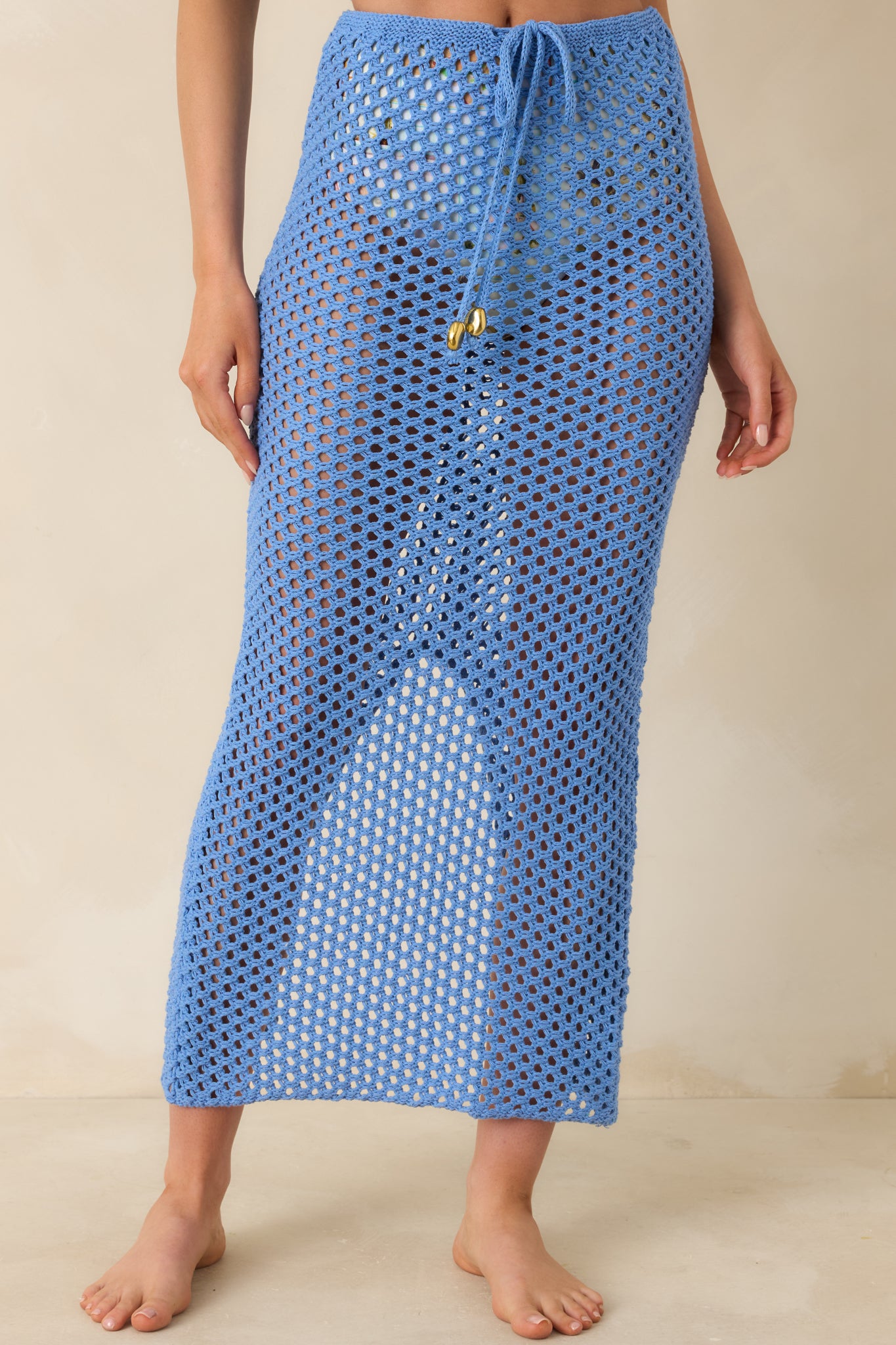 Cropped angled view showing open-knit crochet pattern and adjustable waist detail.