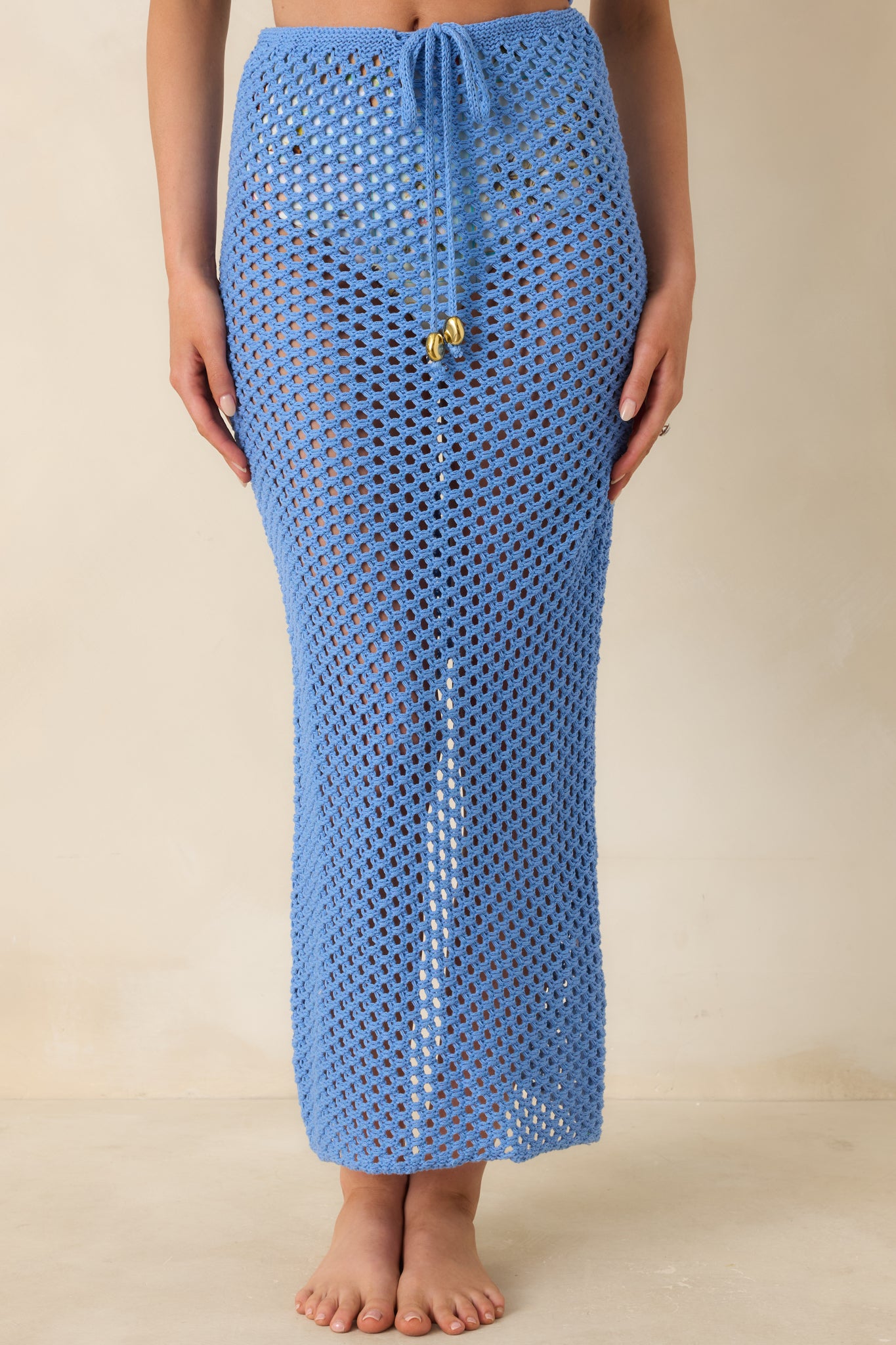Cropped front view highlighting lightweight fabric and airy, textured crochet design.