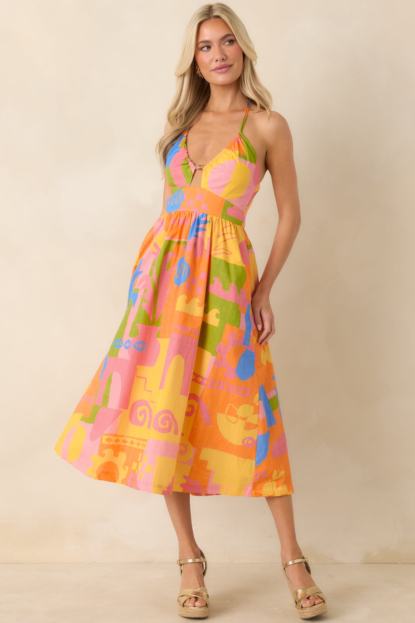 Breezy cotton midi dress with orange tones and easy, flowing skirt movement.