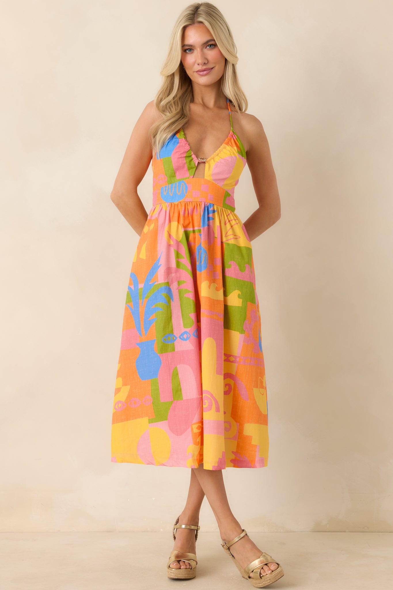 Fitted bodice midi dress with halter neckline and vibrant multi-color print.
