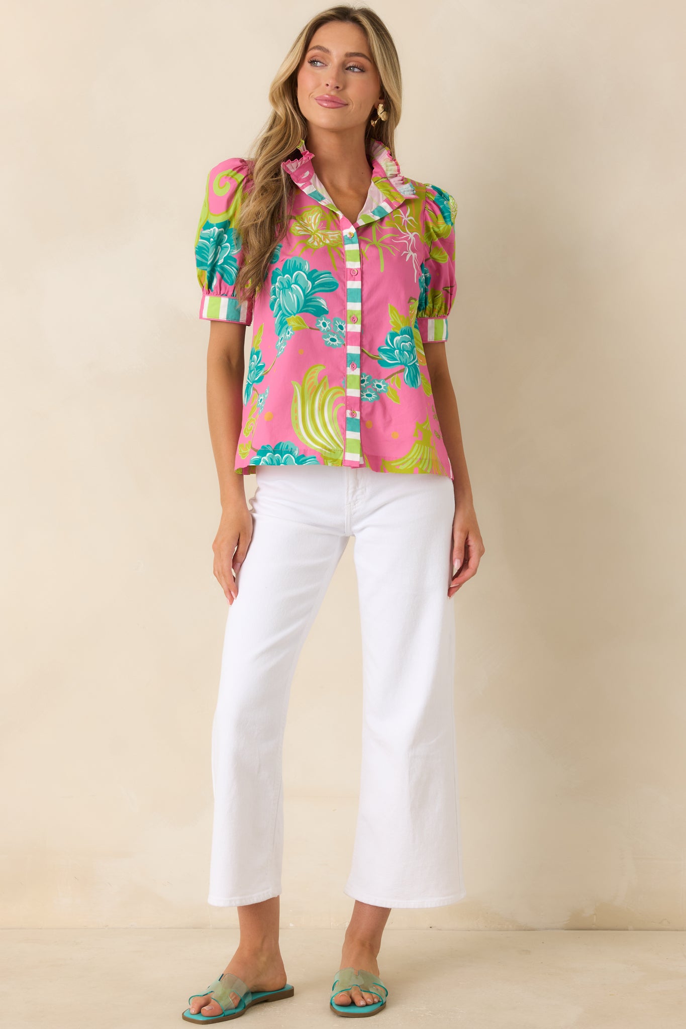 Pink printed top showcasing striped cuff accents on puff sleeves and a crisp woven cotton finish.