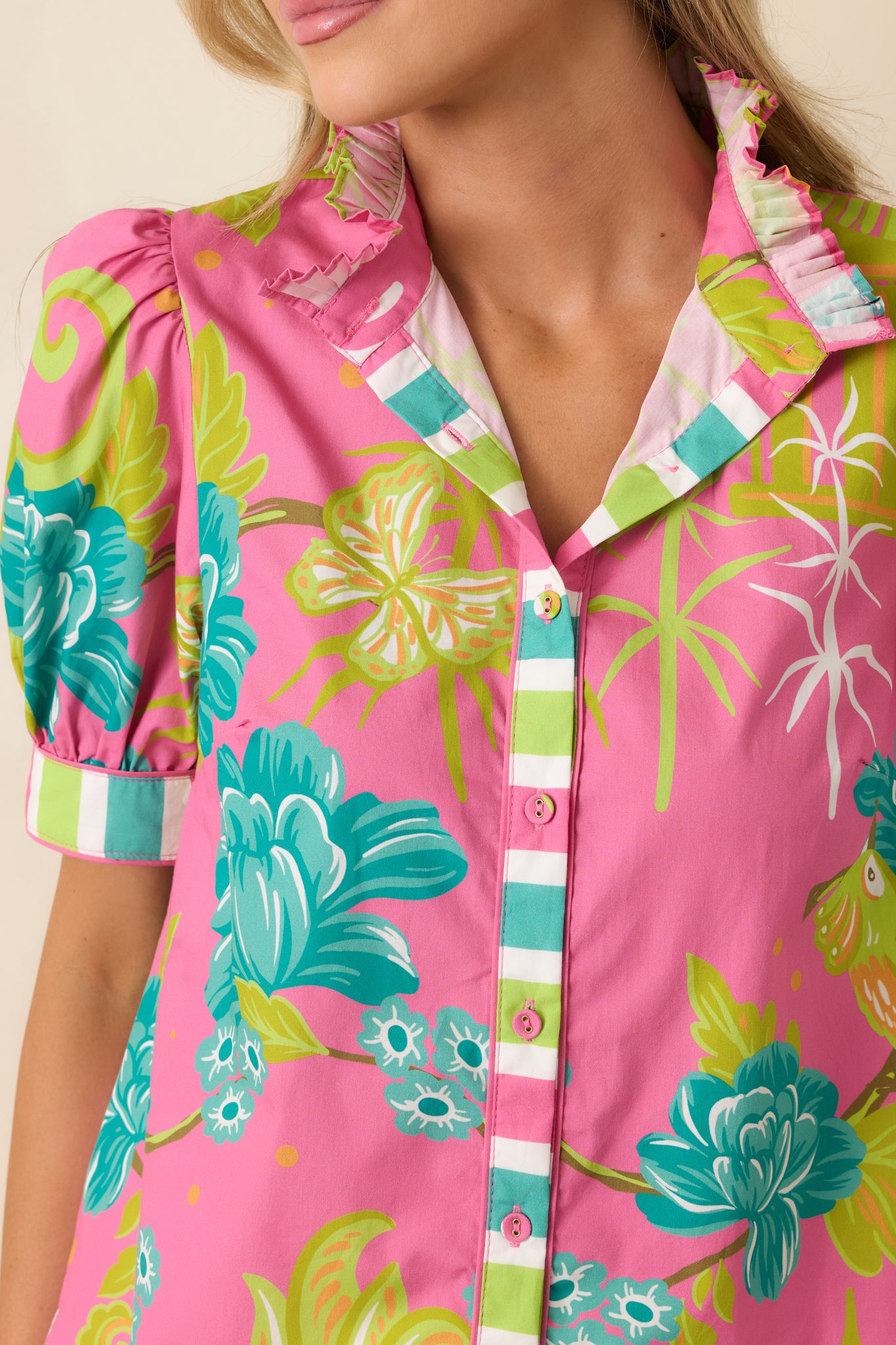 Close-up of the chinoiserie-inspired tropical print showcasing color variation, ruffle collar texture, and cotton weave detail.