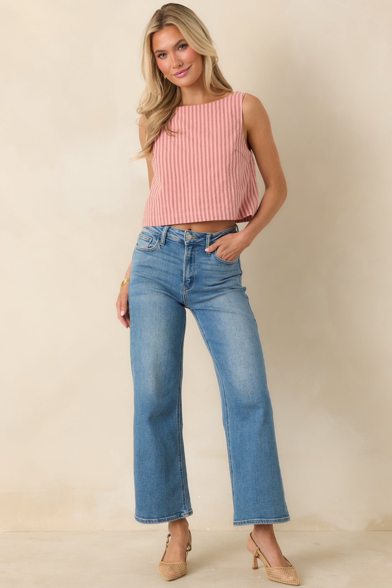 Classic sleeveless top in coral pink stripes with a smooth front silhouette and cotton linen texture.