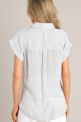 Back view of this charcoal stripe top that features a collared neckline, a full button front, a functional breast pocket, and a split hemline.