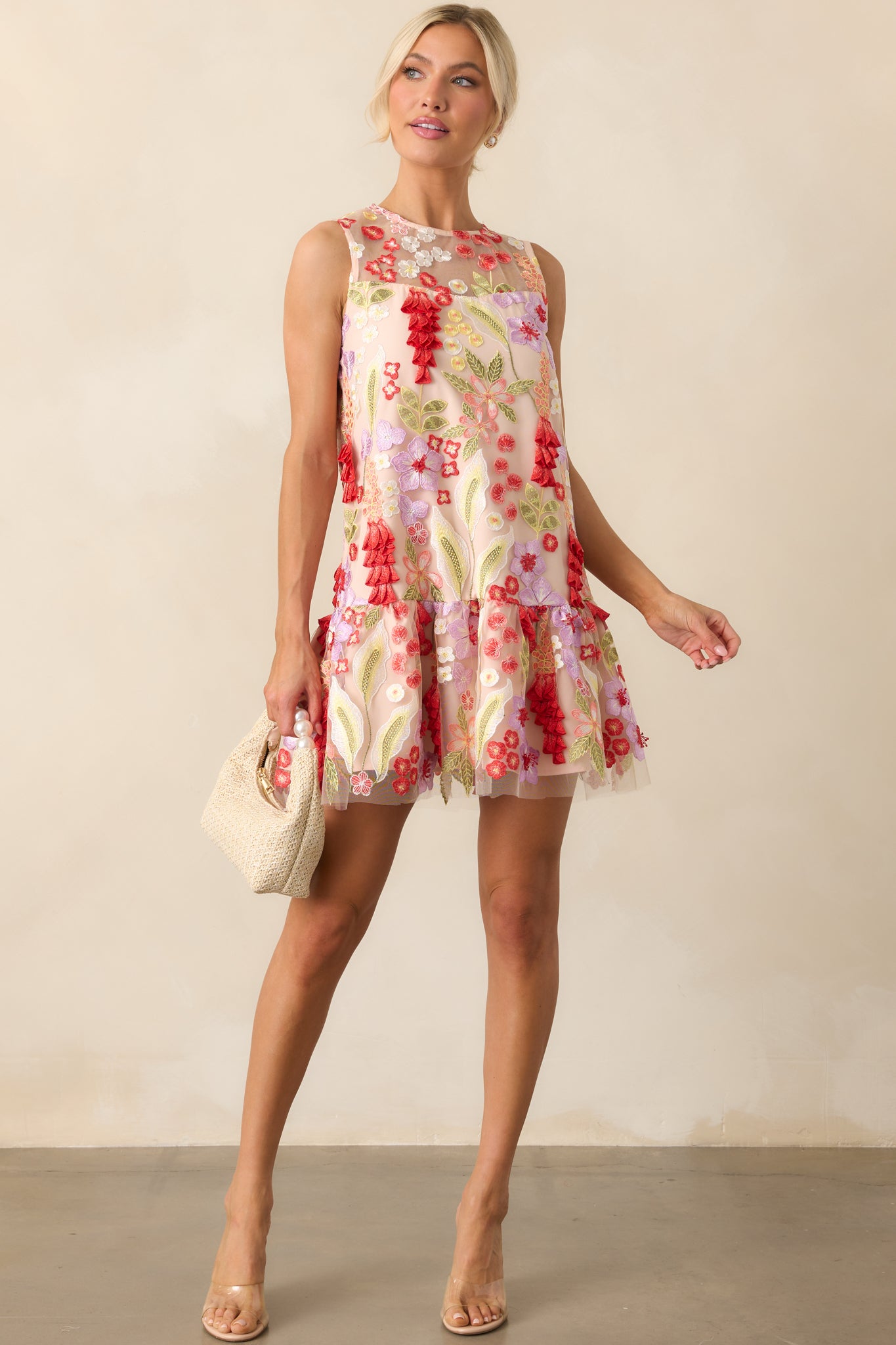 Full-length image of the mini dress, highlighting the sleeveless design and drop waist bottom tier skirt.