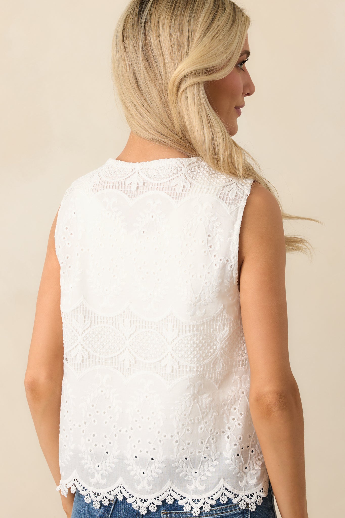 Rear view of the top displaying its clean sleeveless cut and continuous eyelet detailing across the back panel.