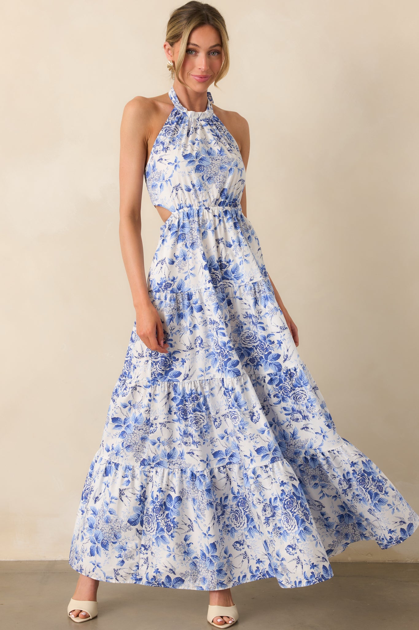 Front view of the blue floral maxi dress showing the halter neckline and flowy tiered skirt cascading to the floor.