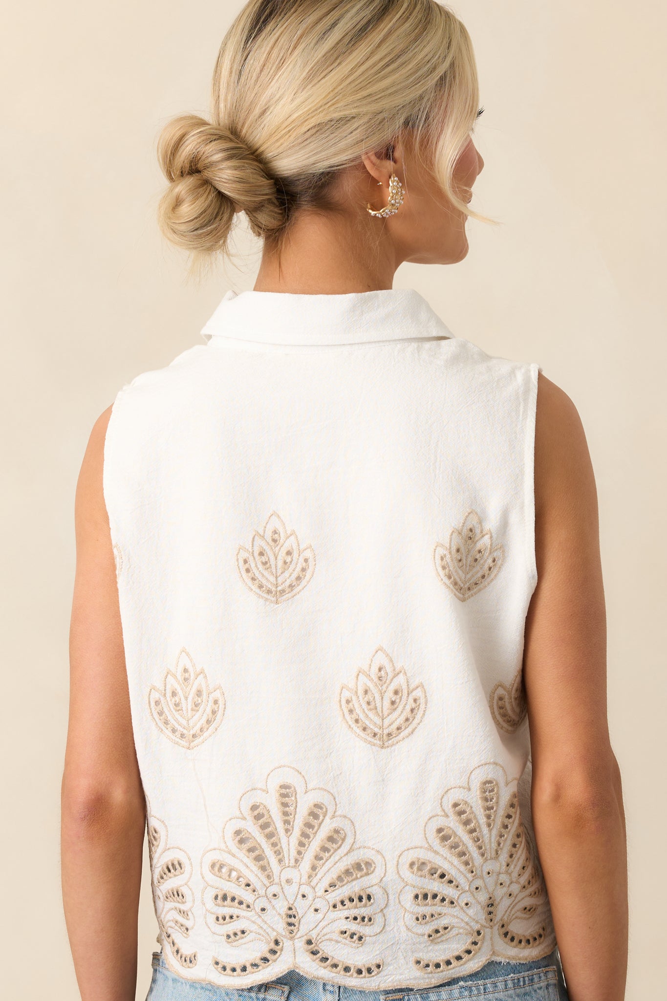 Rear view of the ivory top showing continued eyelet embroidery and clean seam lines at the shoulders and hem.