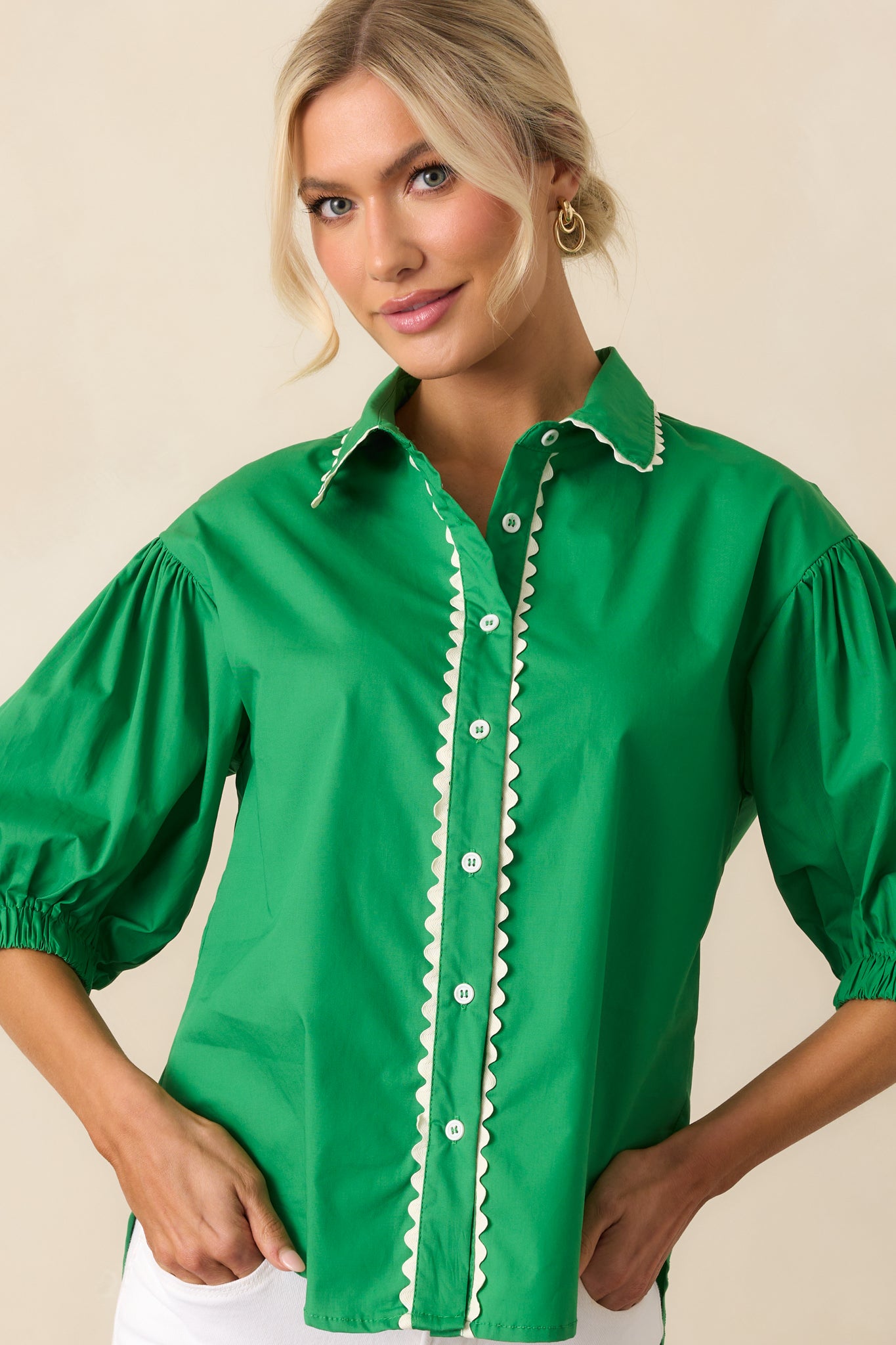 Zoomed-in view of the ric rac trim along the front of the green top, emphasizing the textured design.