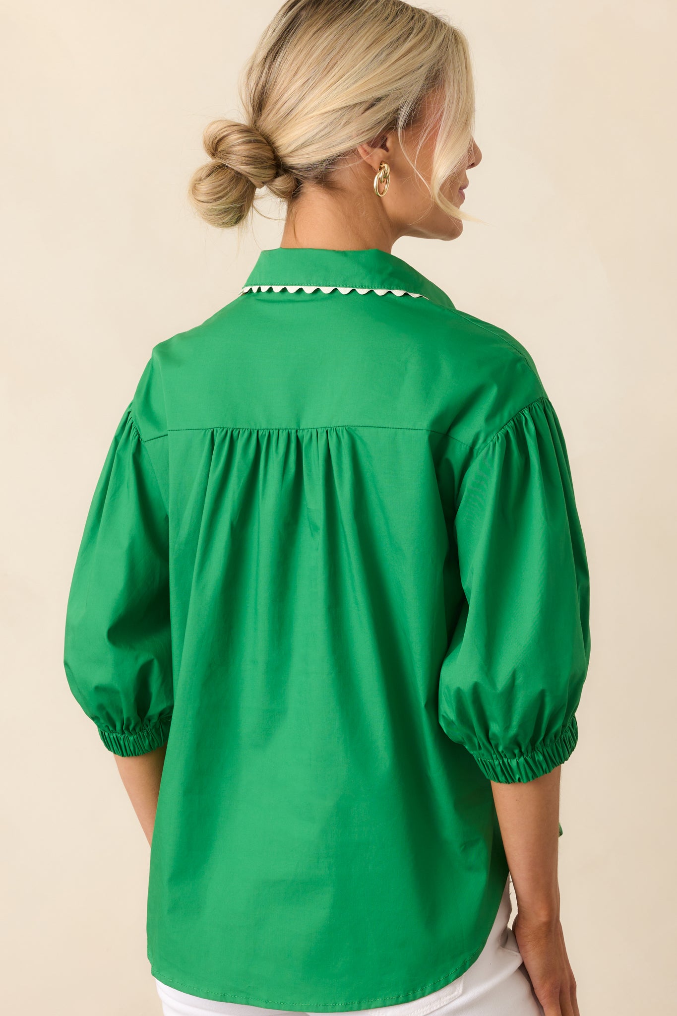 A view from behind of the green top, featuring a relaxed fit and soft, lightweight fabric.