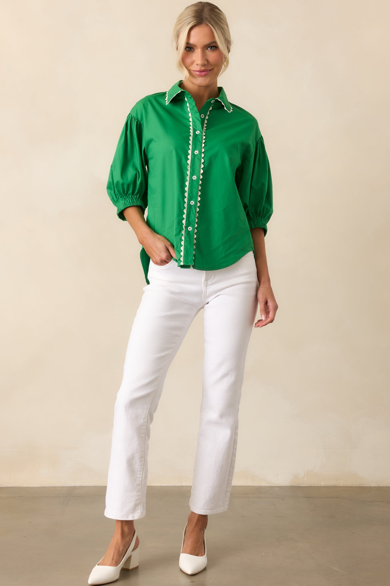 Full-length image of the green top, highlighting the white ric rac trim and half length sleeves.