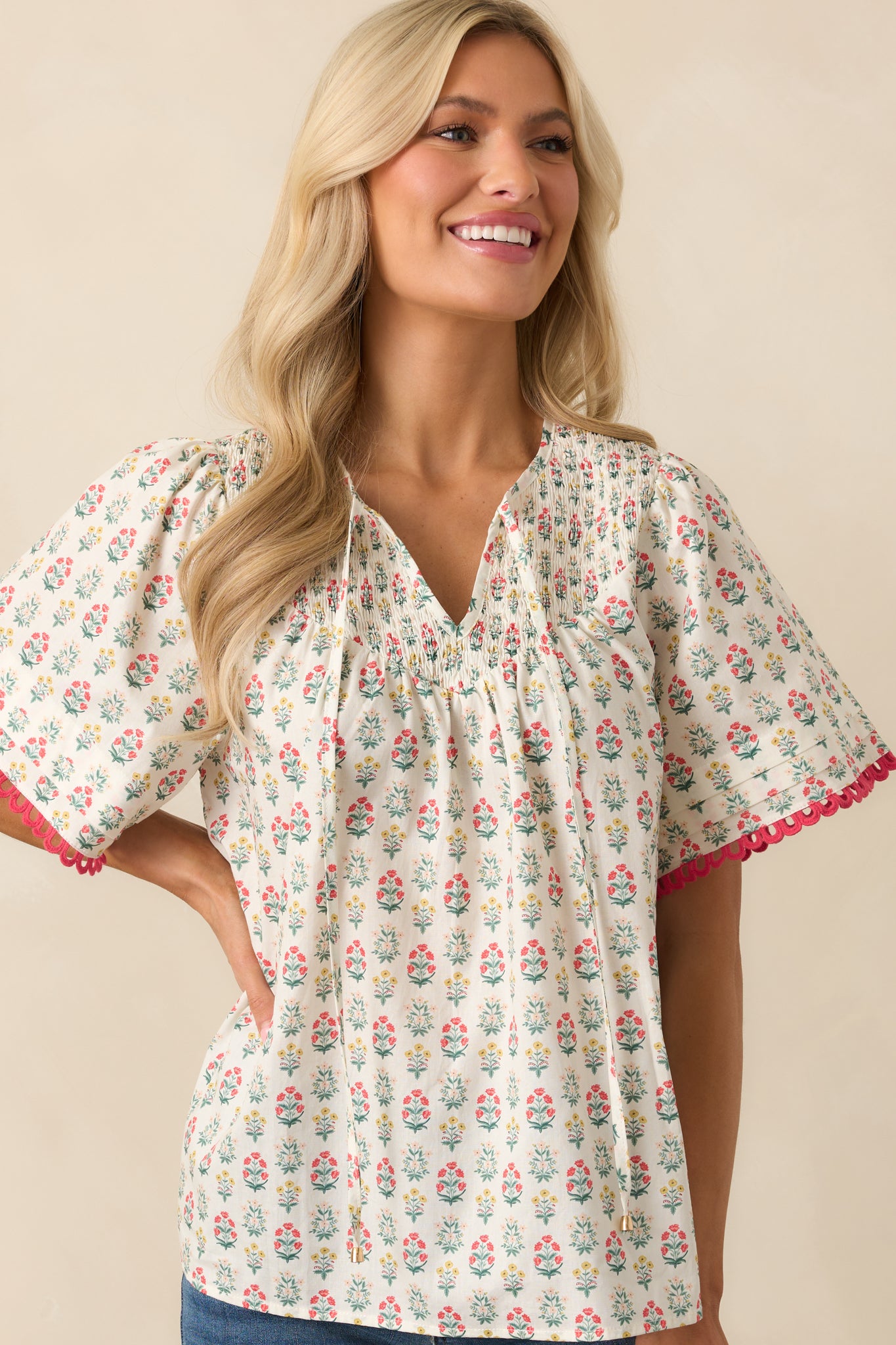 Another cropped photo highlighting the top's soft, lightweight fabric, optional self-tie front, and red detailing around the sleeve cuffs.