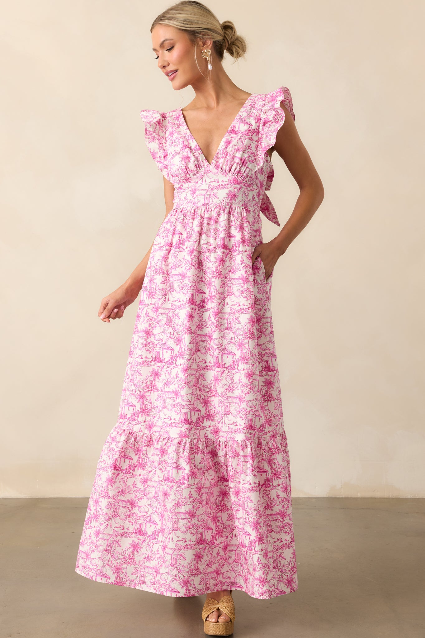 Front-facing view of a pink cotton dress with tropical toile pattern, highlighting the neckline and pocket placement.