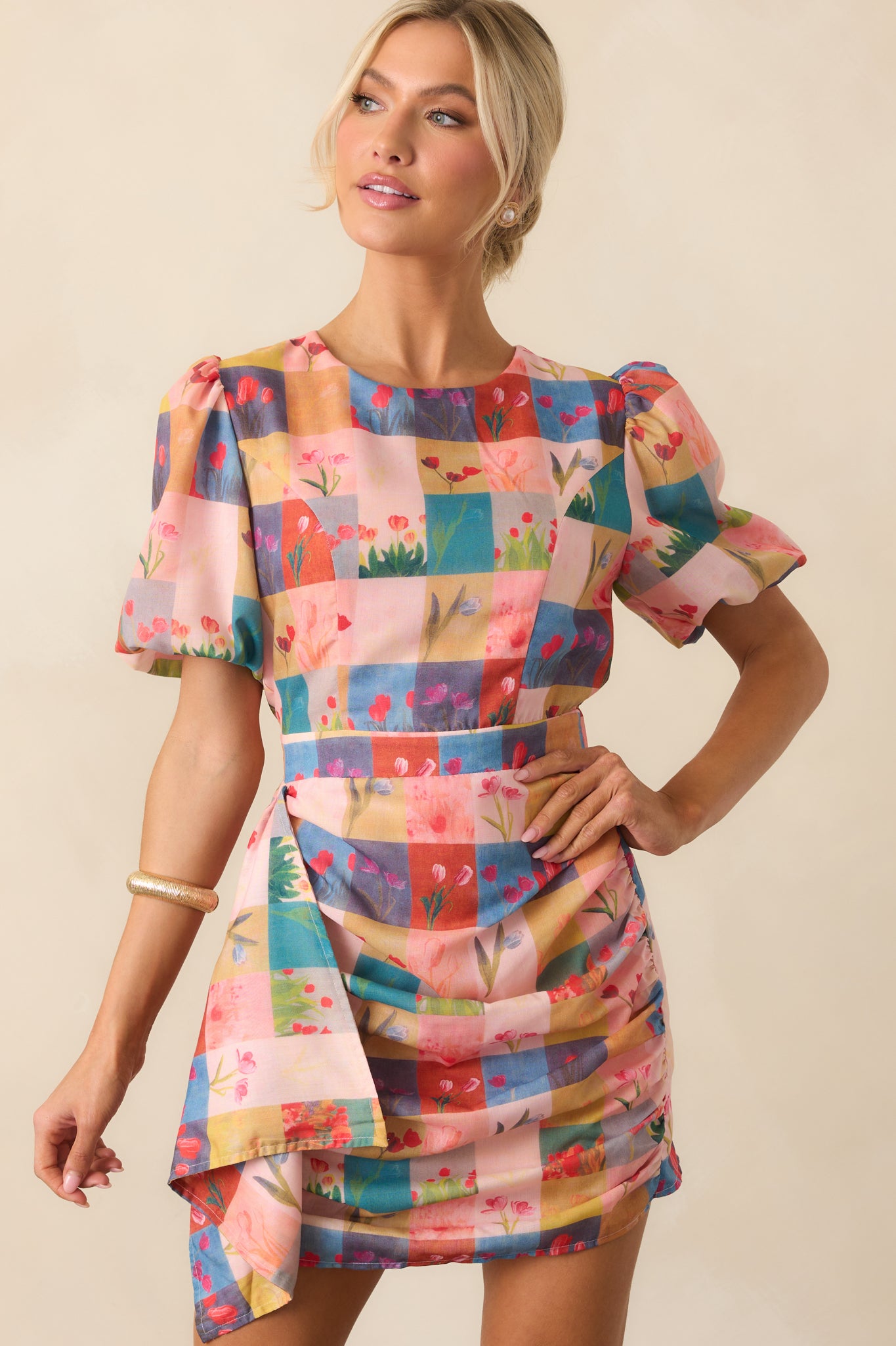 Cropped detail of the draped skirt, showing the layered effect and softness of the blush pink fabric.