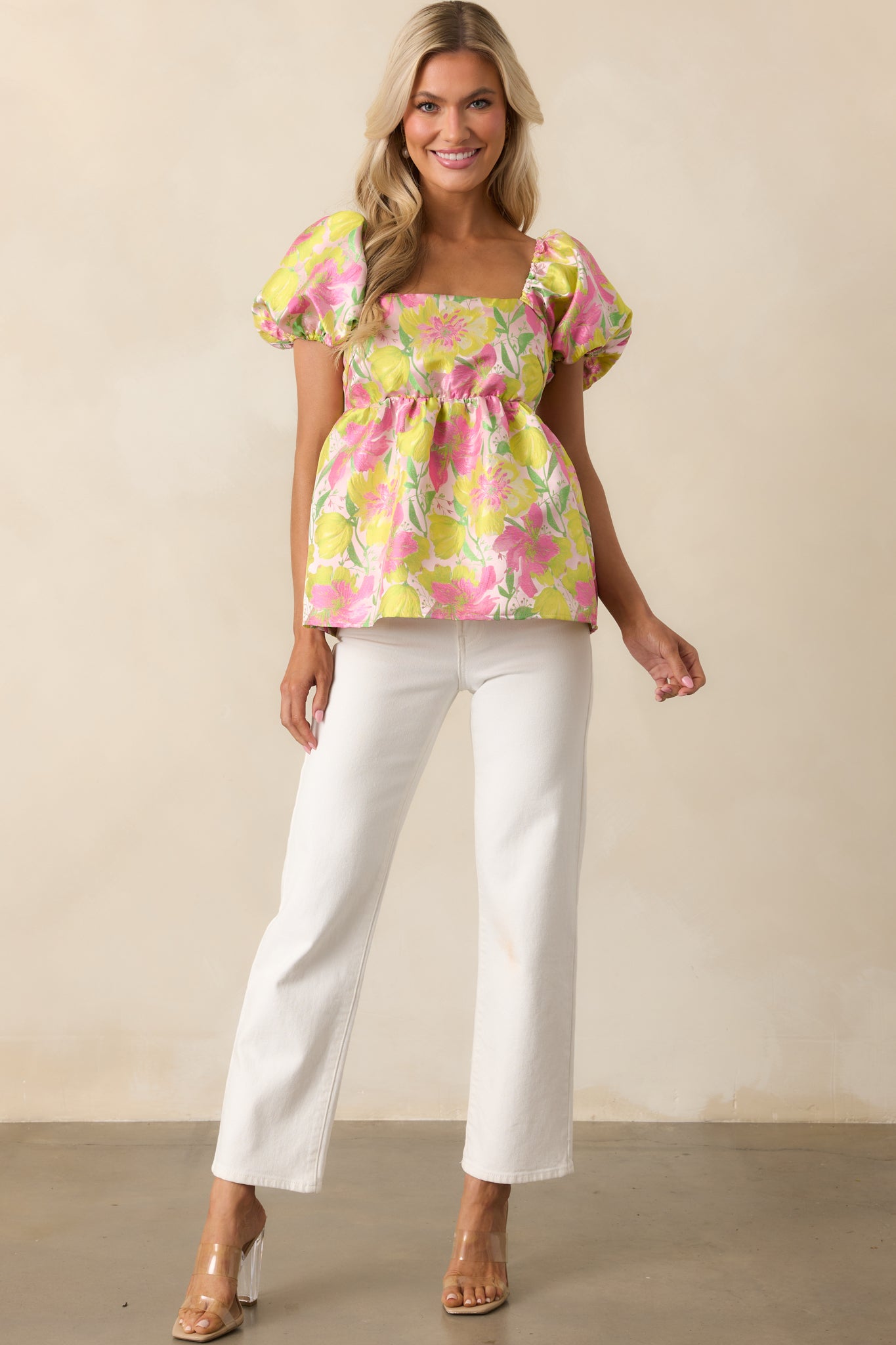 Floral top with delicate elastic straps, puff sleeves, and a softly flared peplum silhouette.