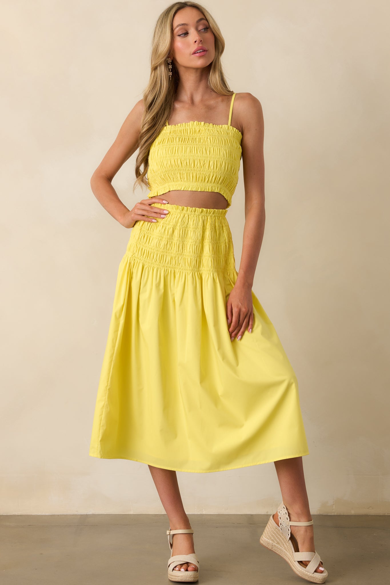 Head-to-toe image highlighting the vibrant yellow color and ruffle-trimmed design of the spaghetti strap top.
