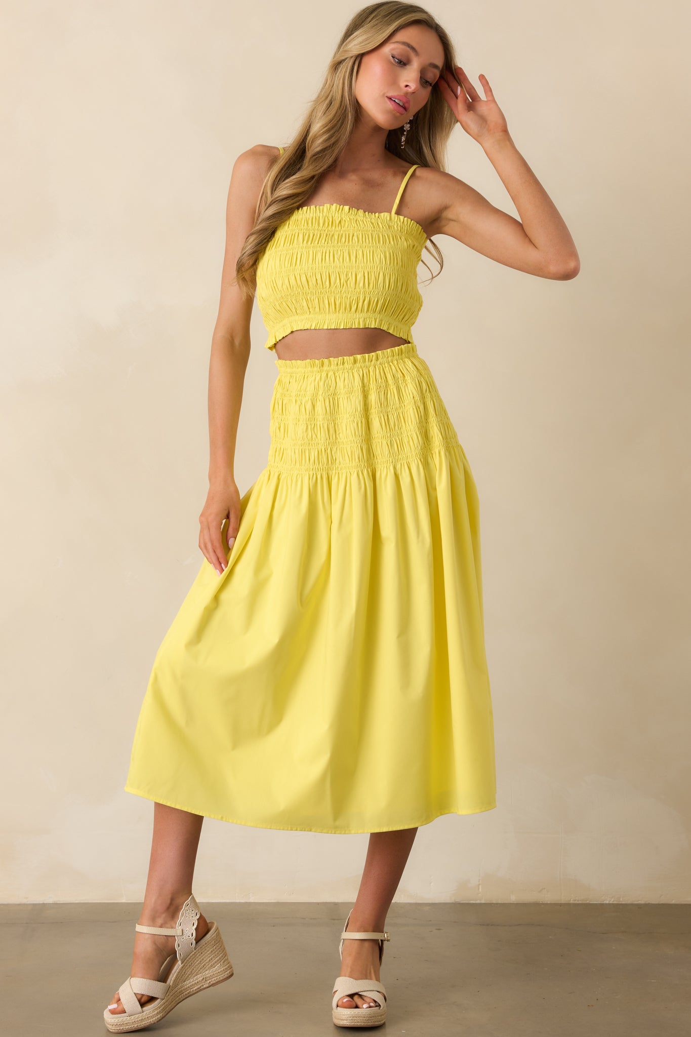 Another front view of the yellow midi skirt captured mid-sway to highlight its airy, flowy design and ruffle trim in motion.
