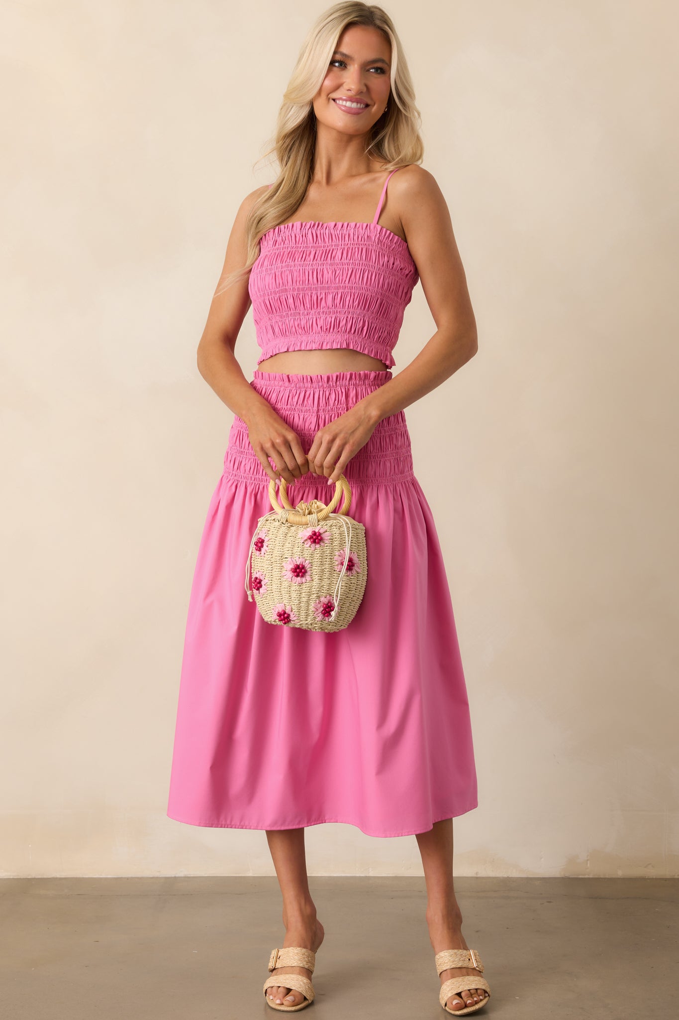 Front view of a vibrant pink midi skirt with a high-rise fit and flowy silhouette.