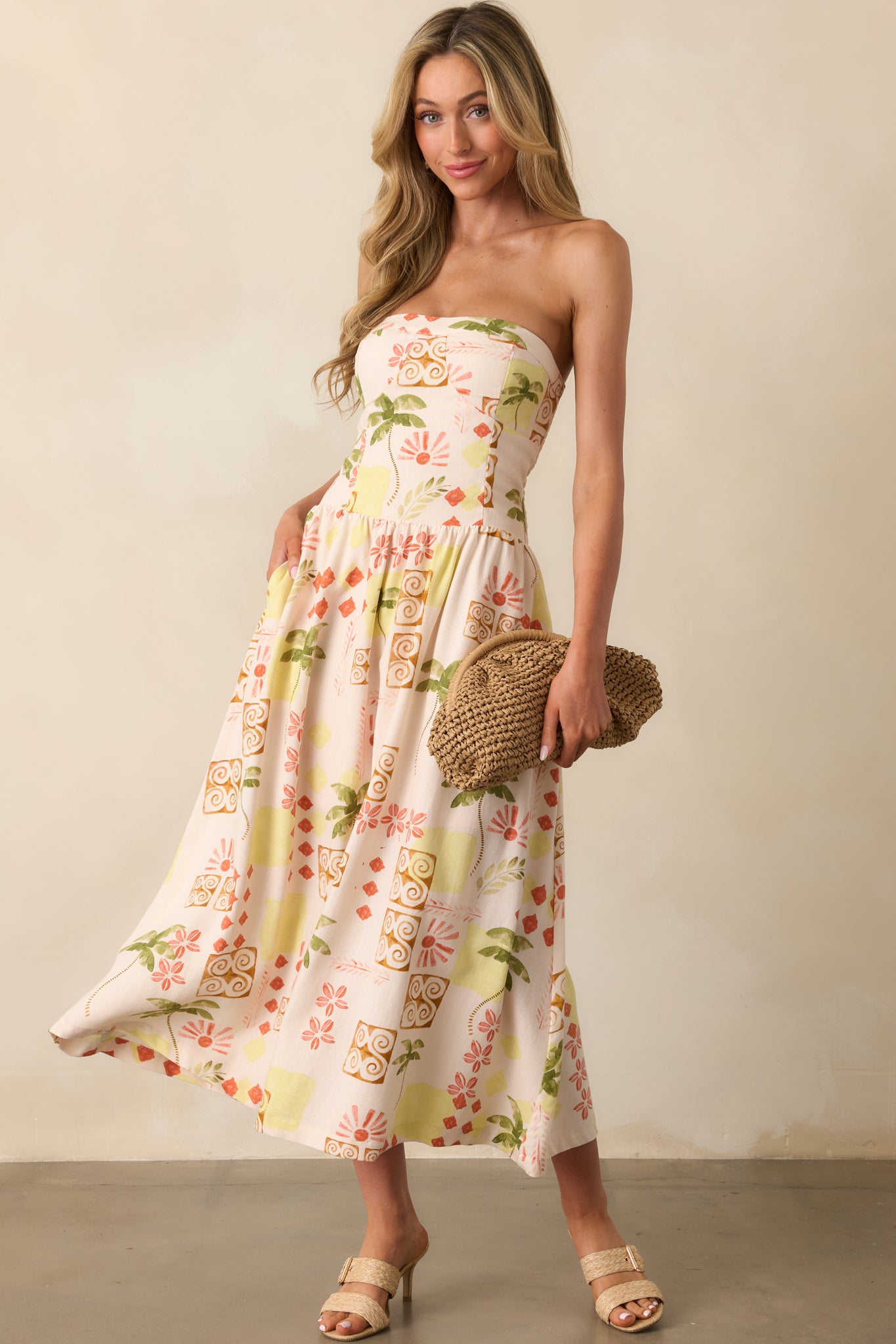Beige strapless dress shown from the front, highlighting the vibrant multicolor tropical pattern and structured bodice stitching.