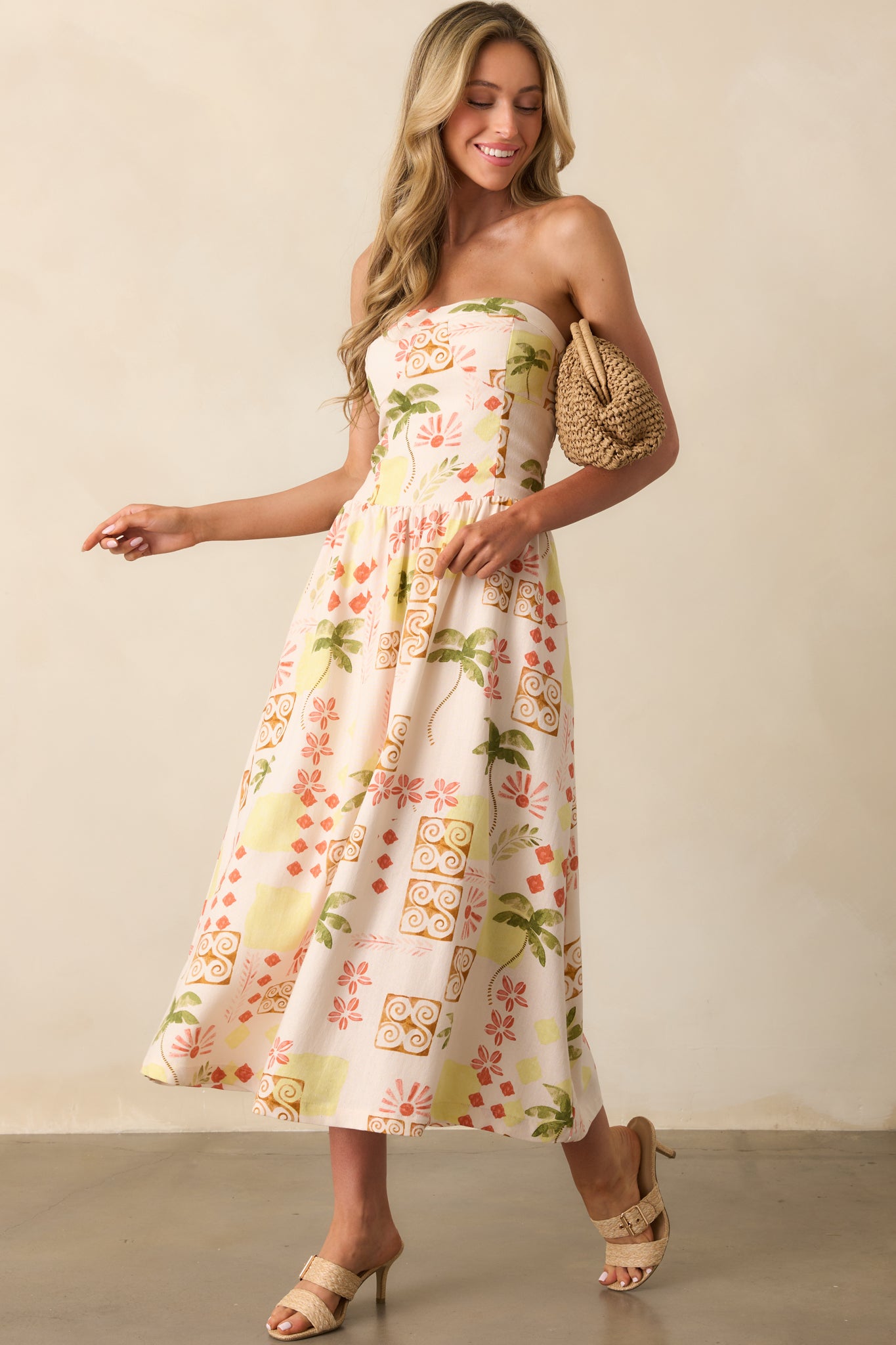 Front view of a linen-rayon blend strapless dress, with a fitted top and loose, breezy skirt accented by functional pockets.