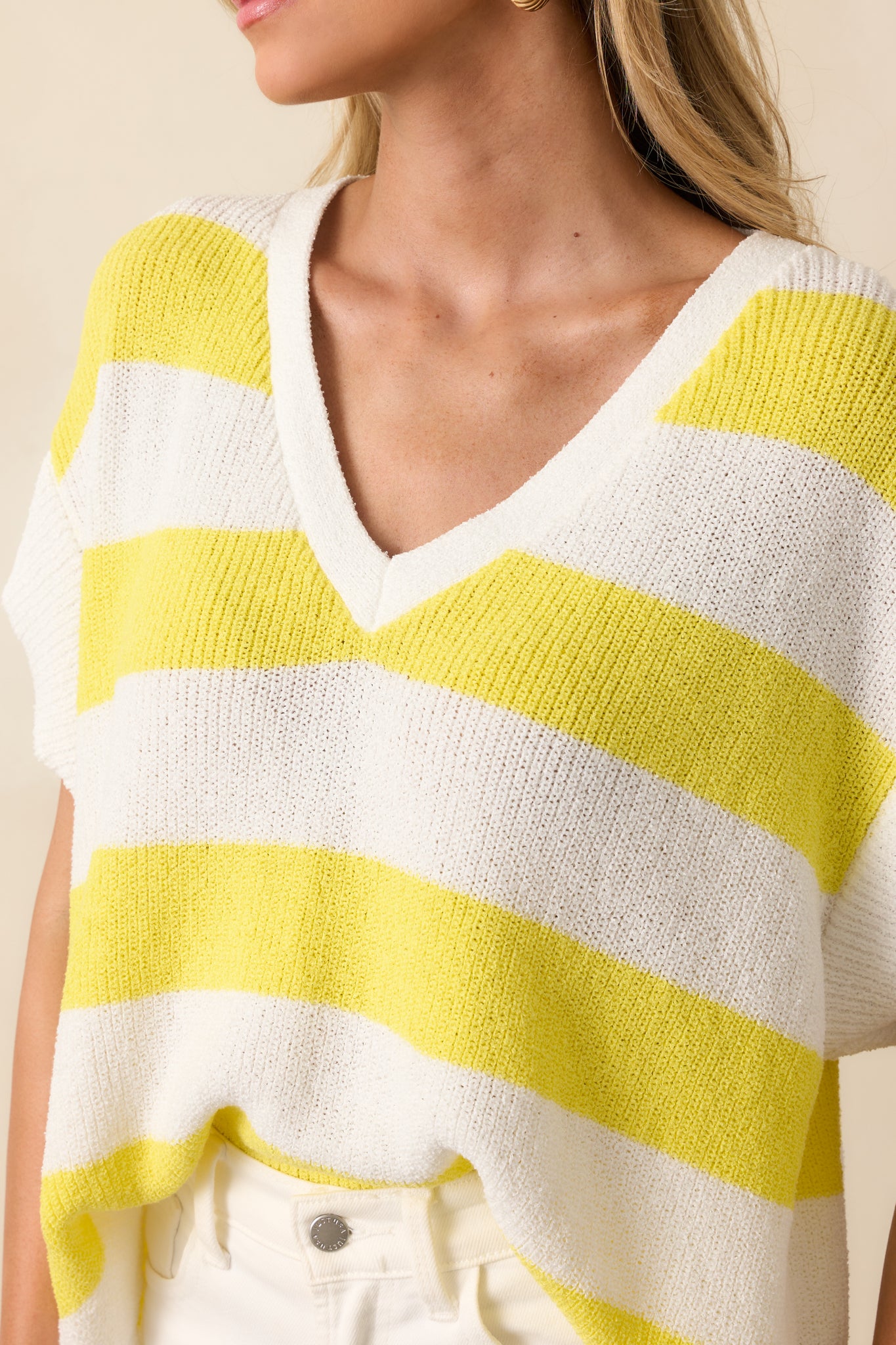 Close-up image of the loose knit fabric highlighting the stitch detail and striped color variation.