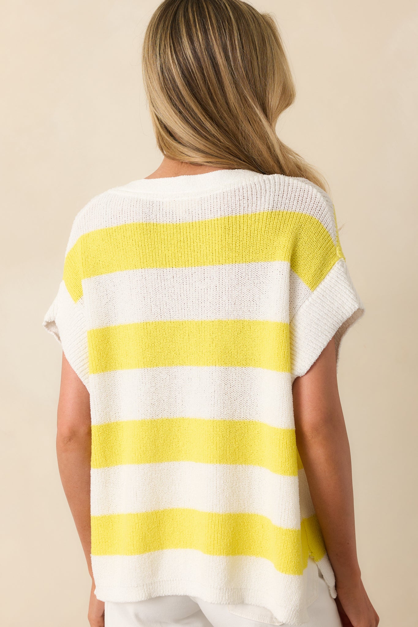 Rear view of the striped top displaying the oversized fit and continuation of the yellow and white stripes.