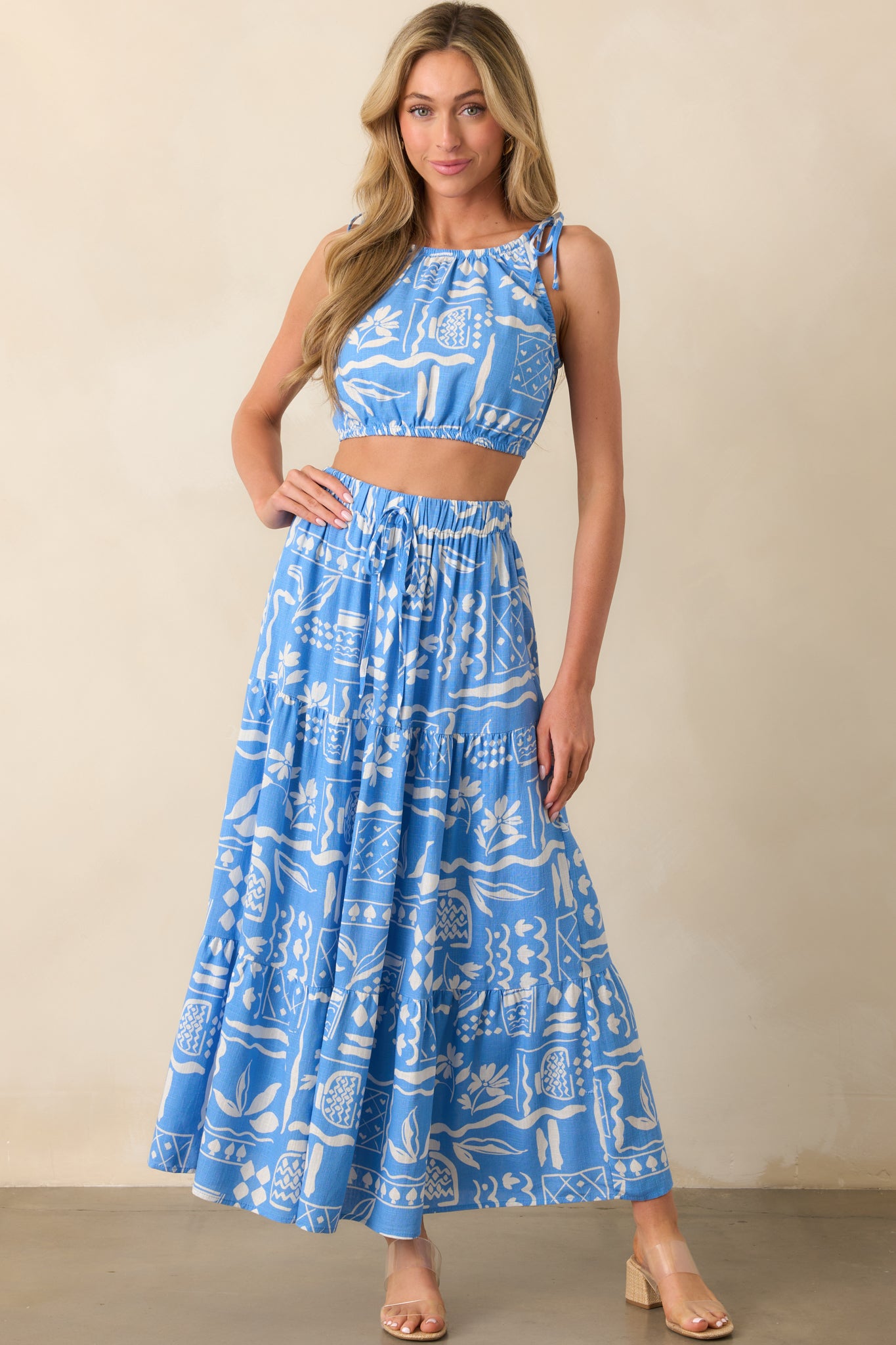 Front-facing shot highlighting the lightweight rayon-linen blend fabric and blue lining beneath the white print.