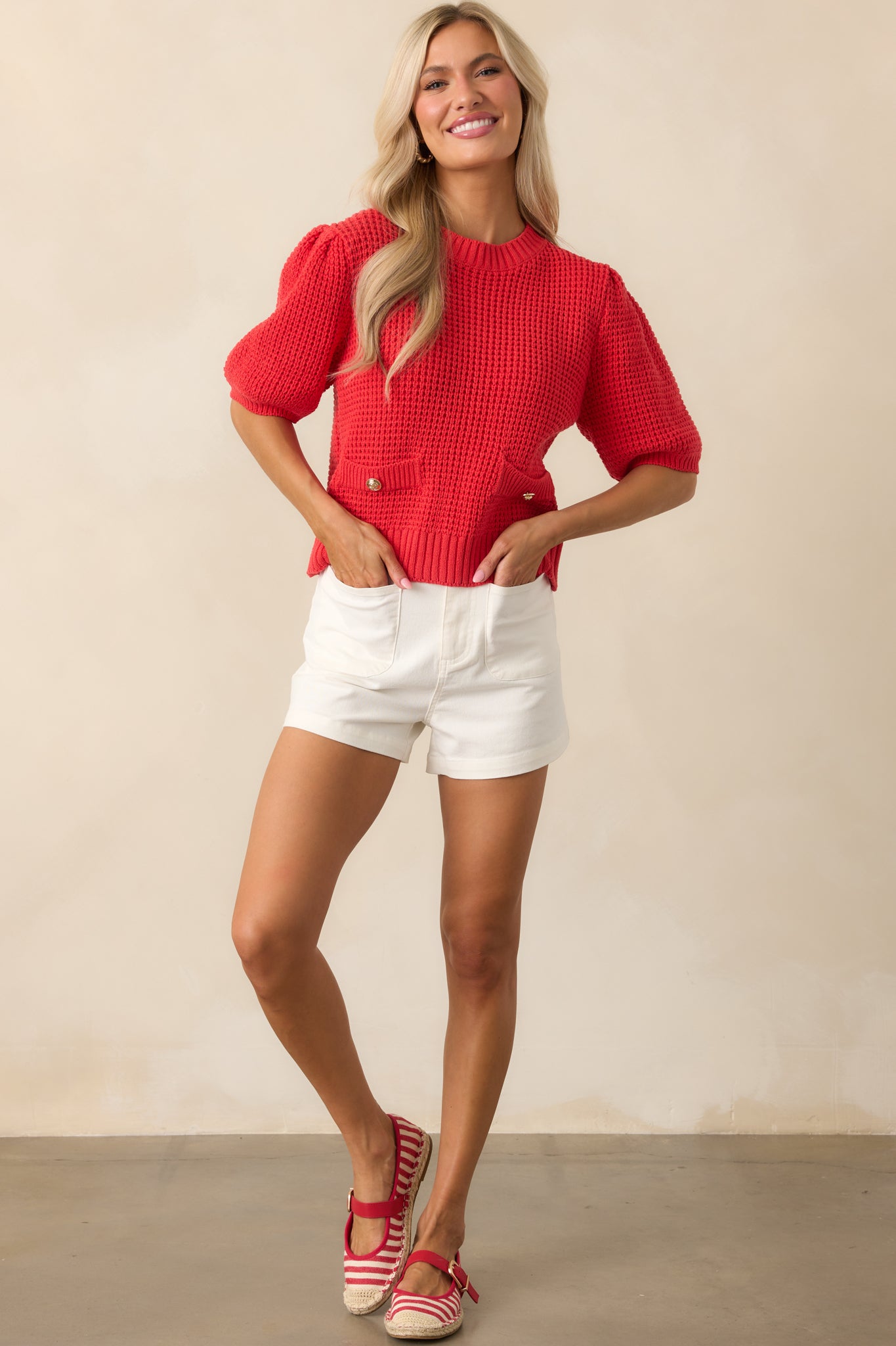 Front view of the ivory high-waisted shorts showing full length and structure, including front patch pockets and belt loops.