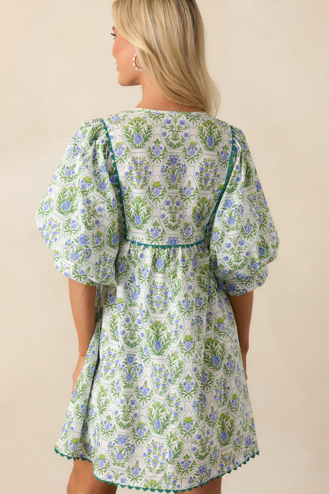 A view from behind of the mini dress, showing the flow of the fabric and continuation of the bold print.