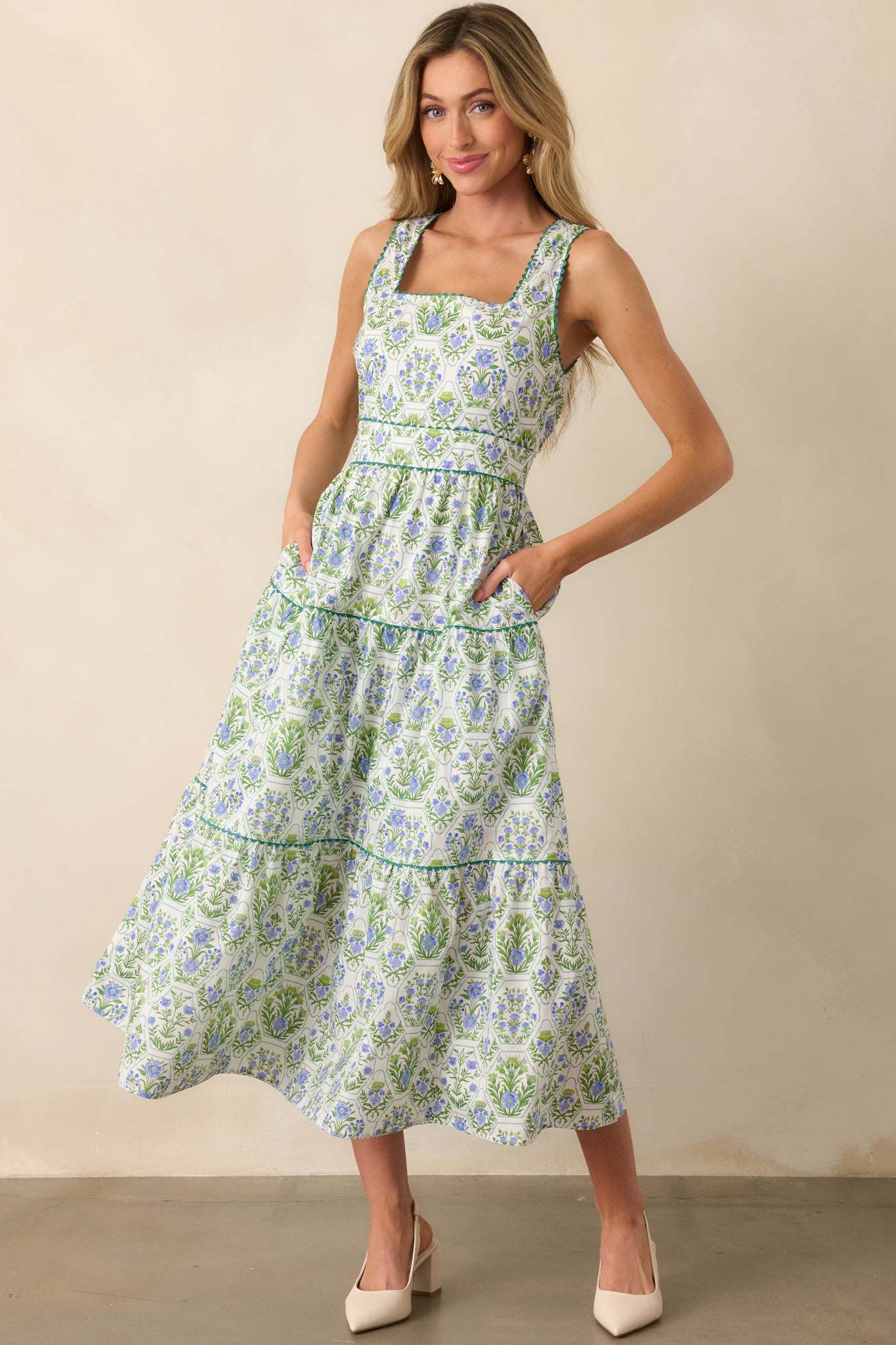 Printed maxi dress with floral and geometric patterns, shown in a full body shot highlighting the structured bodice and airy skirt.