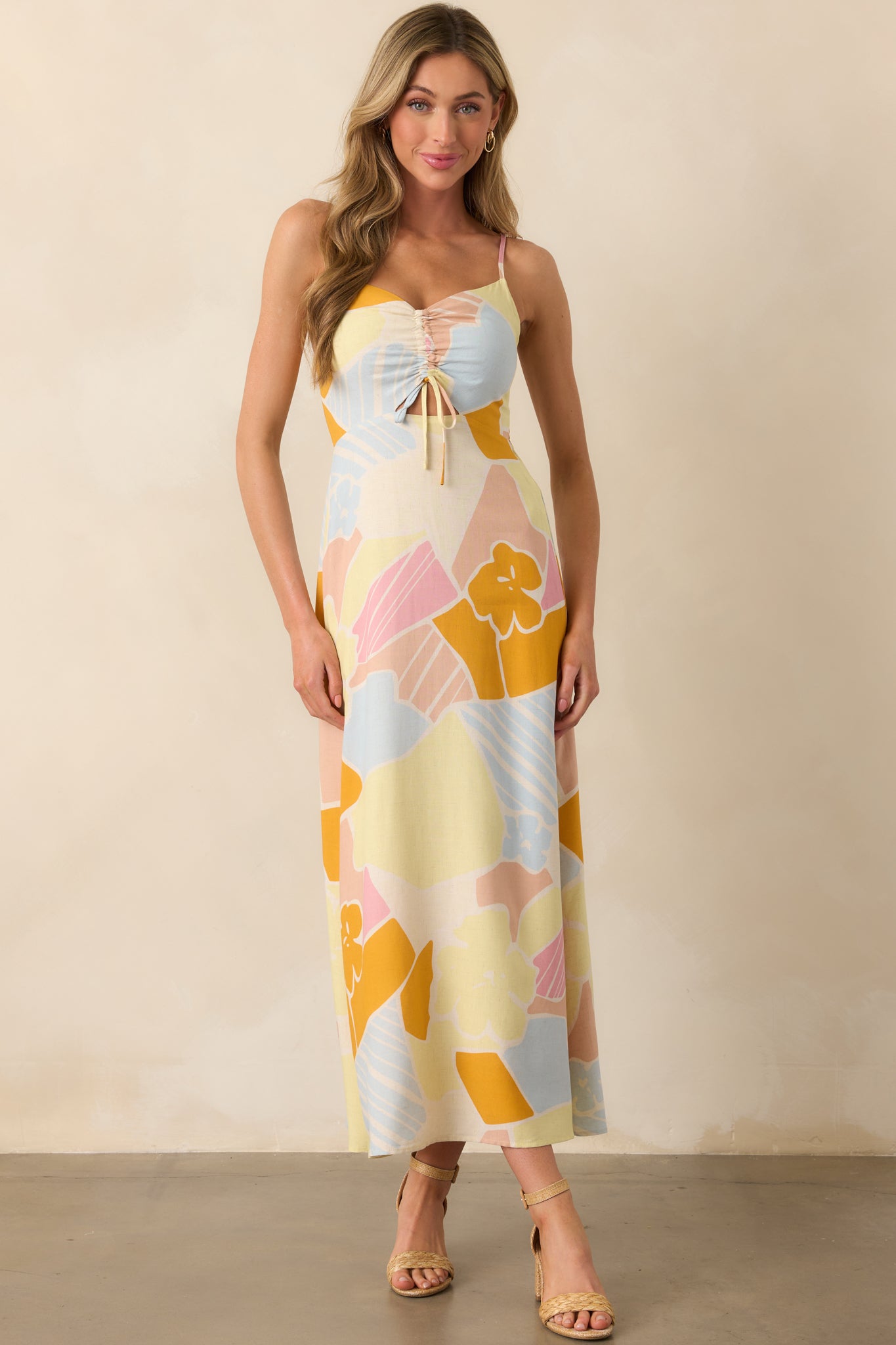 Front view of the mellow yellow maxi dress showcasing the v-neckline, cutout detail, and delicate spaghetti straps.
